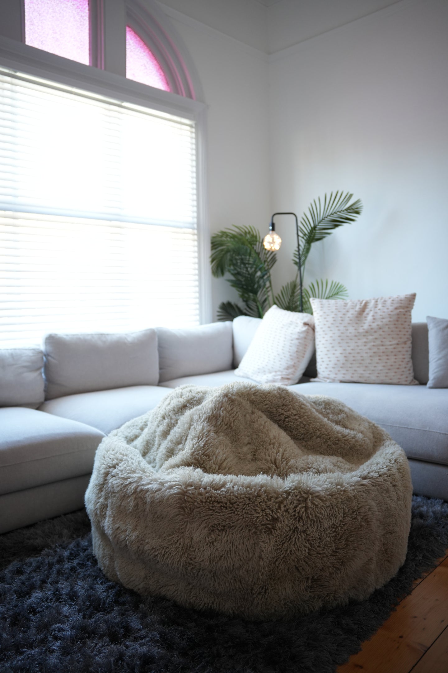 Beige sheepskin bean bag chair with soft fluffy texture, front view. - Yellow Earth Australia