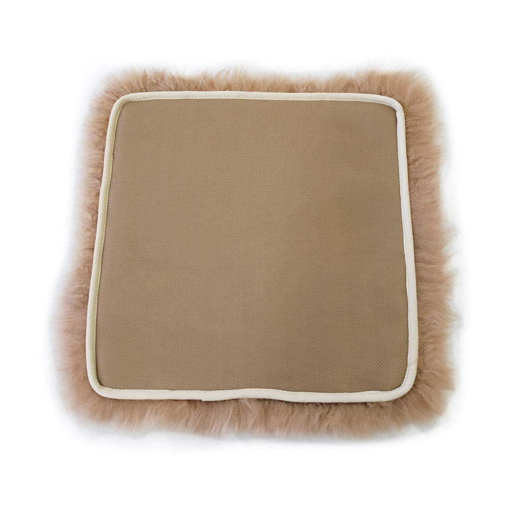 Luxurious tan sheepskin cushion cover with fluffy wool trim, top-down view. - Yellow Earth Australia