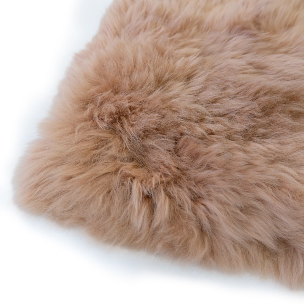 Fluffy beige sheepskin rug with soft wool texture viewed from above. - Yellow Earth Australia