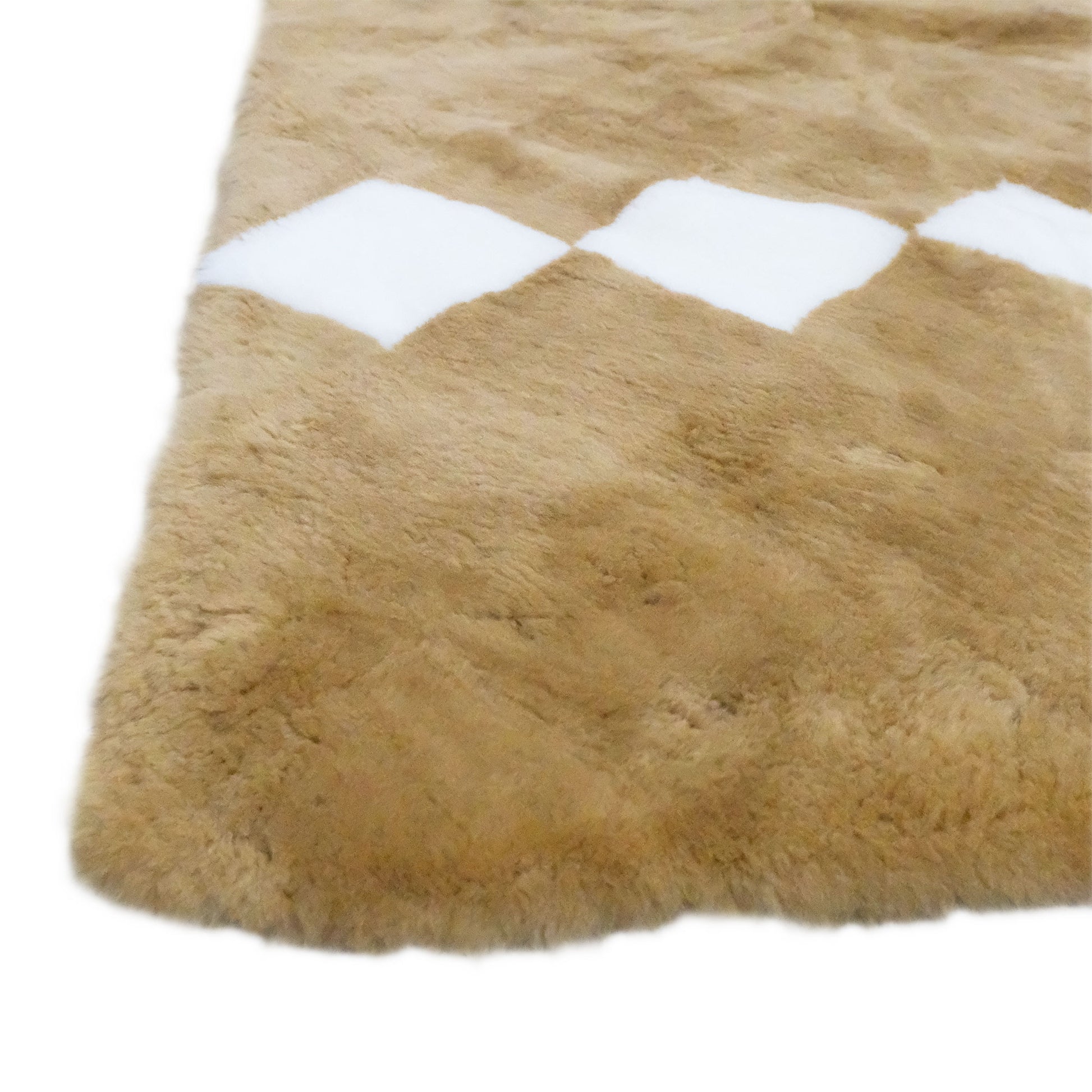 Beige sheepskin rug with white stripe detail, top-down view showing soft wool texture. - Yellow Earth Australia