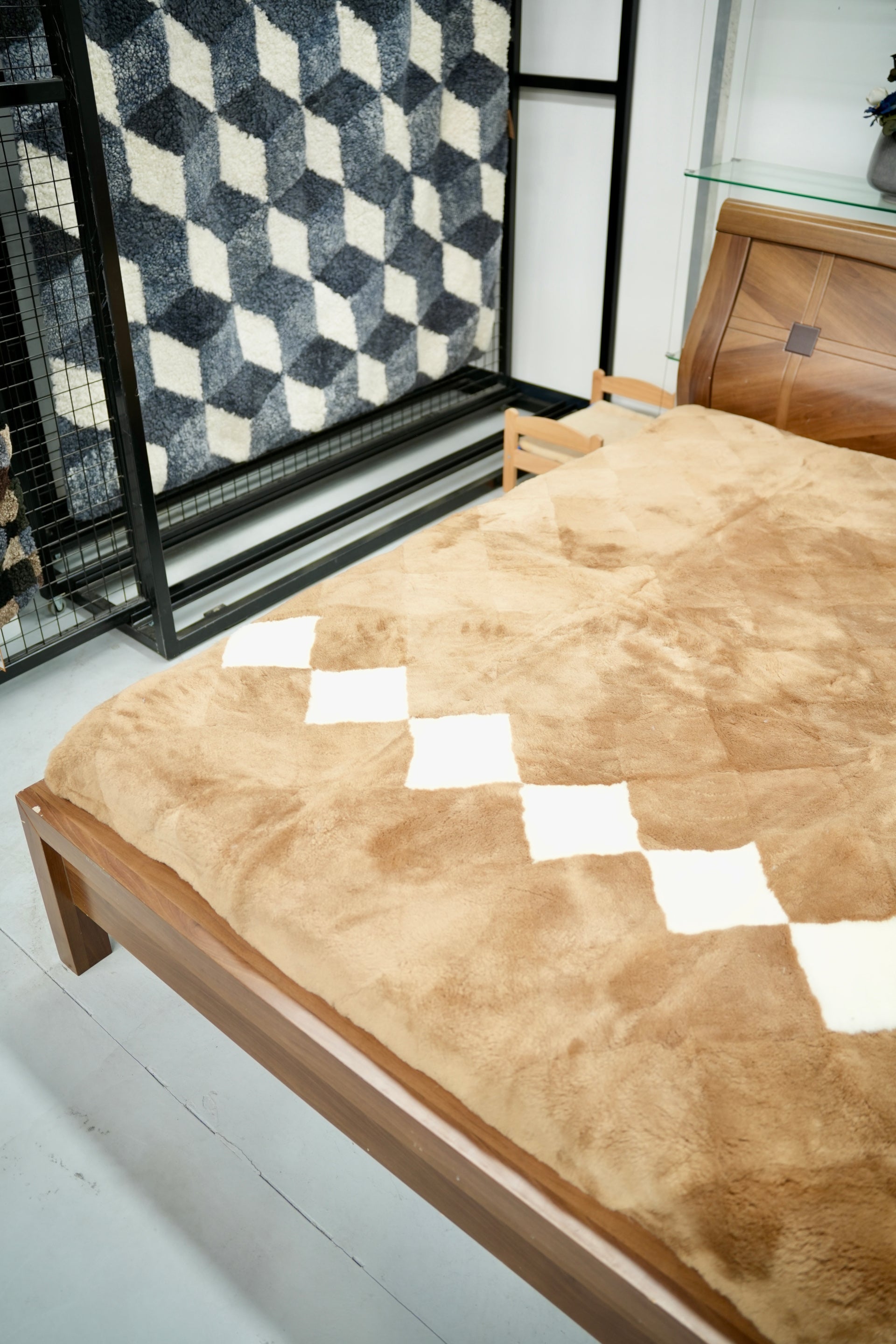 Natural sheepskin bedding with white diamond pattern, top-down view on wooden bed frame. - Yellow Earth Australia