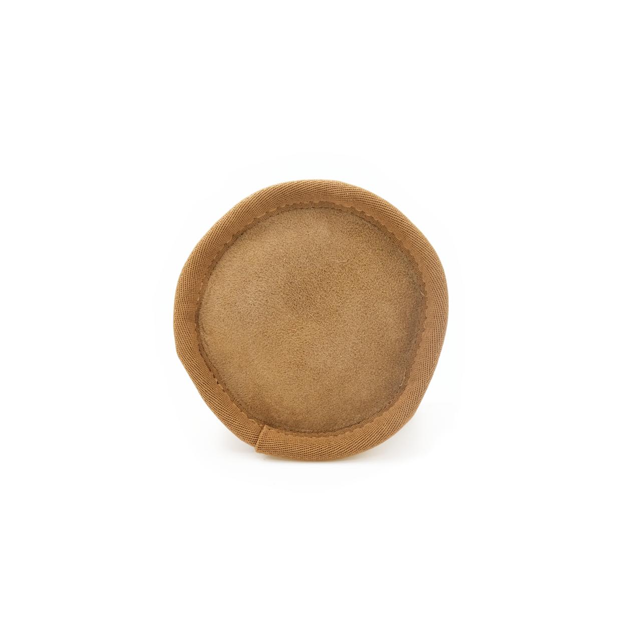 Tan sheepskin round cushion viewed from above, showing soft wool texture. - Yellow Earth Australia