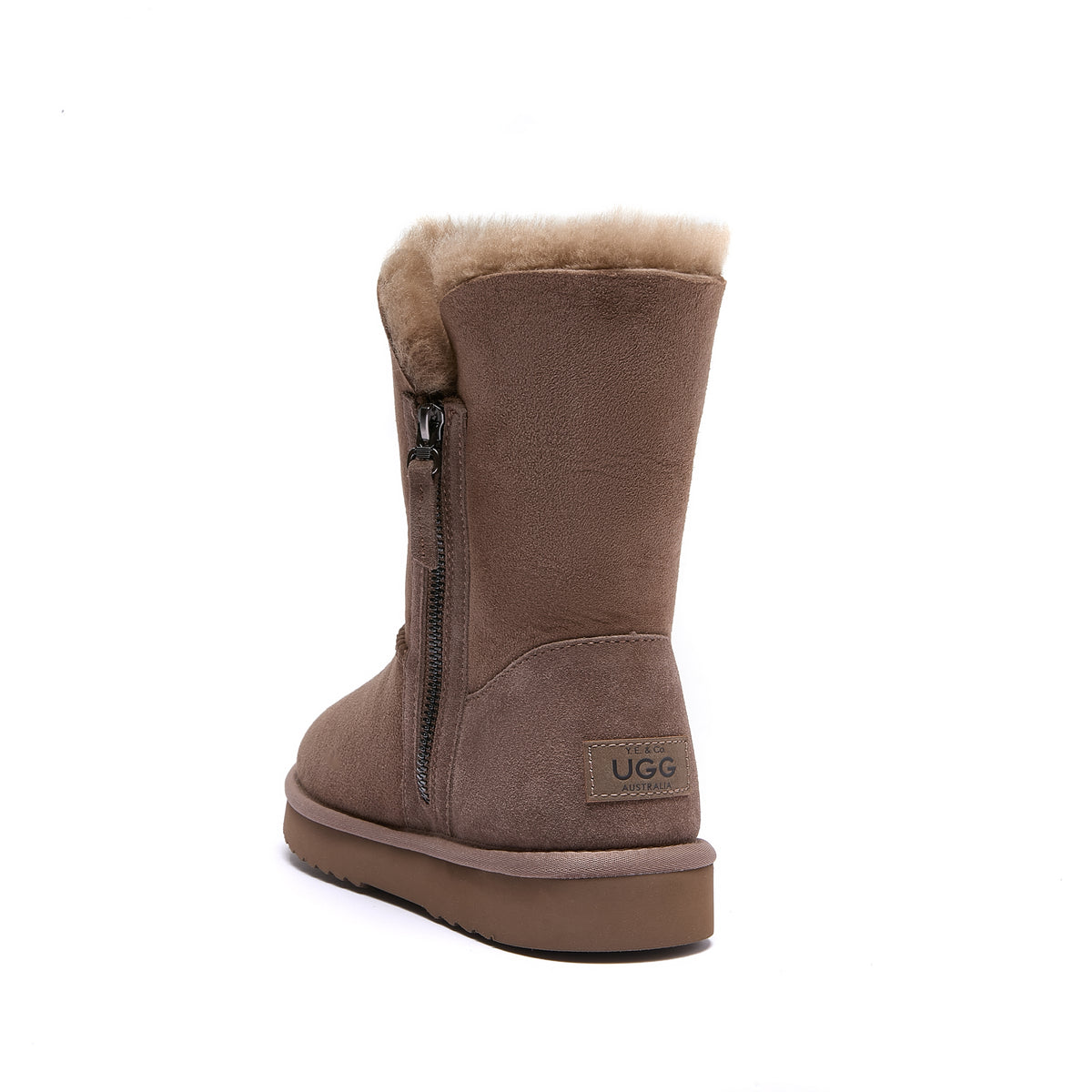 A single brown suede UGG bootie with a side zipper and a light tan shearling lining, shown from the back on a white background.