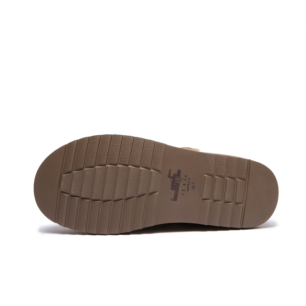 The outsole of a brown boot or shoe, showing a textured tread pattern and a molded logo with the text 'Y.E. & Co' on a white background.