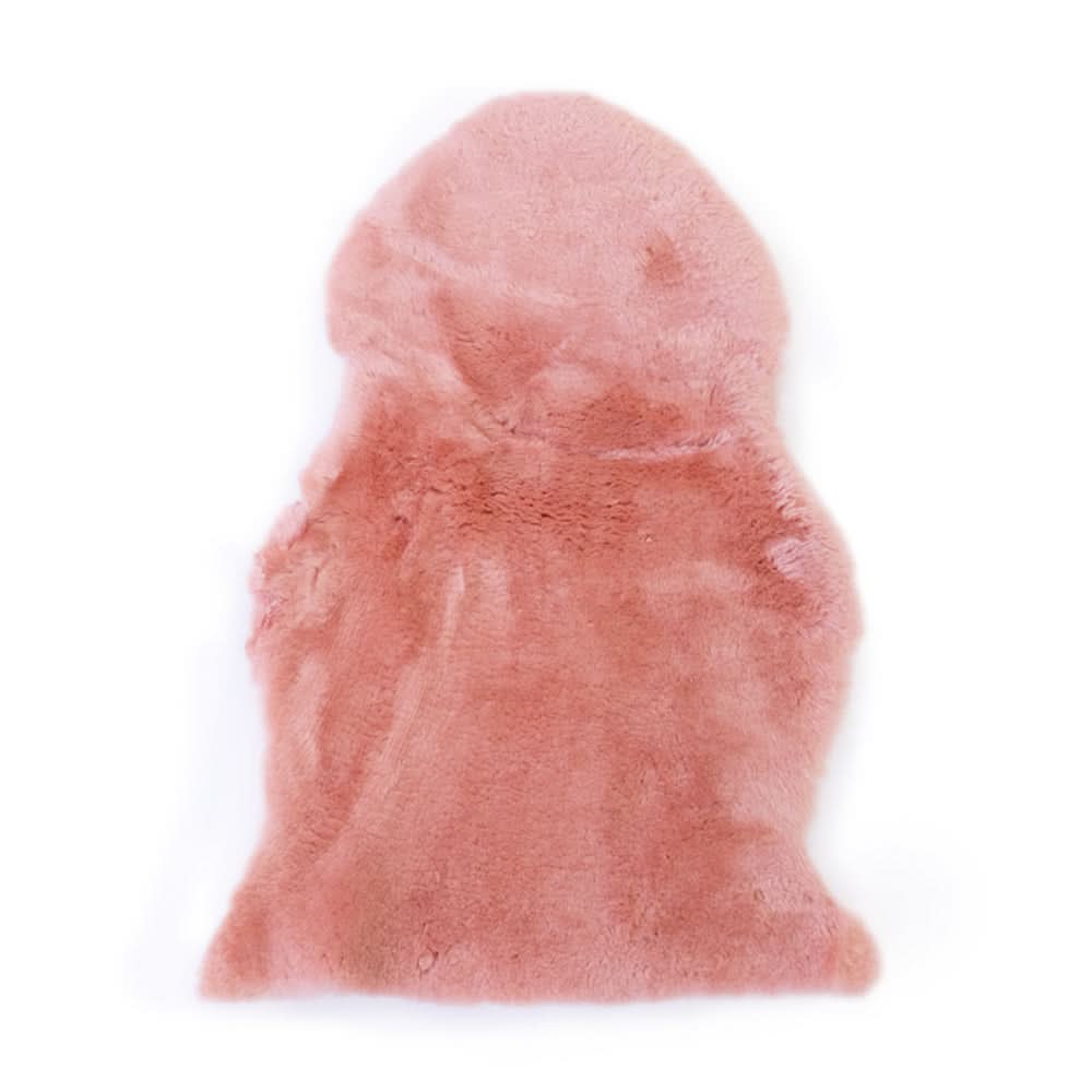 Dusty pink sheepskin rug with soft wool pile viewed from above on white background. - Yellow Earth Australia