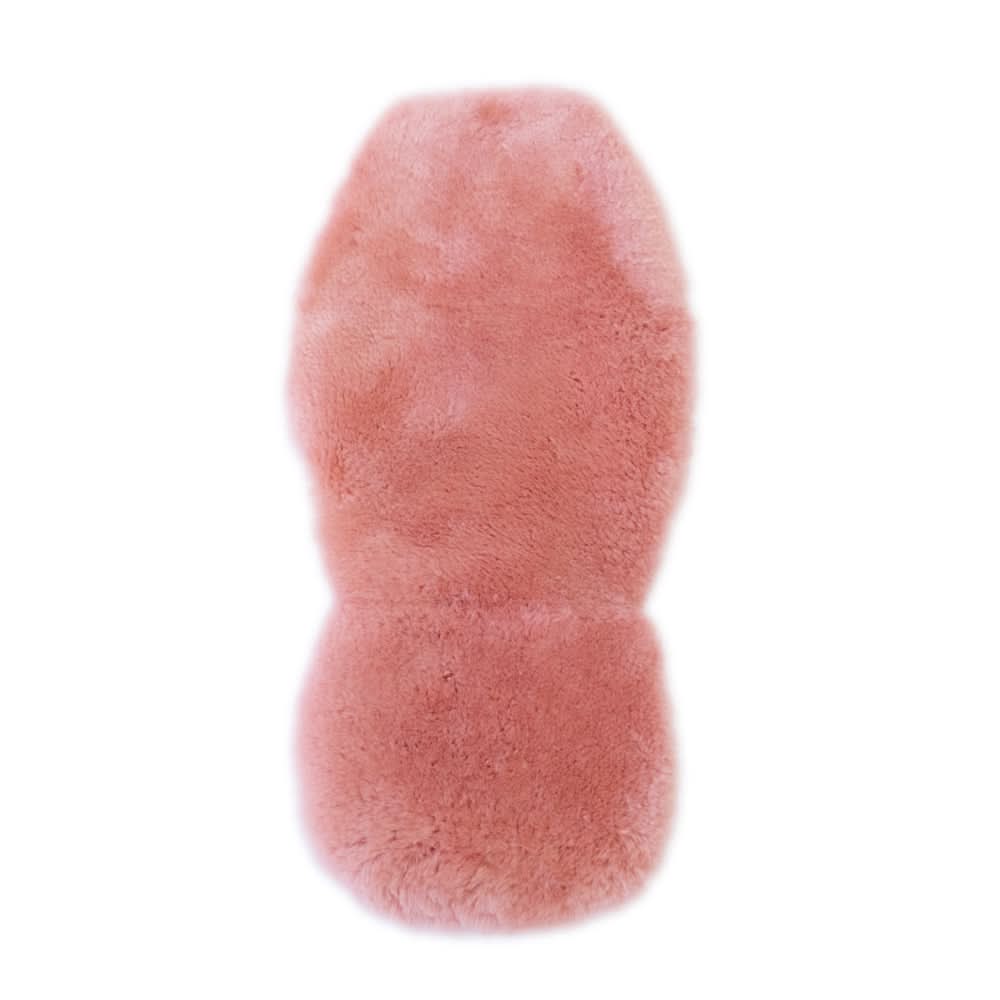 Pink sheepskin rug with soft wool pile viewed from above on white background. - Yellow Earth Australia