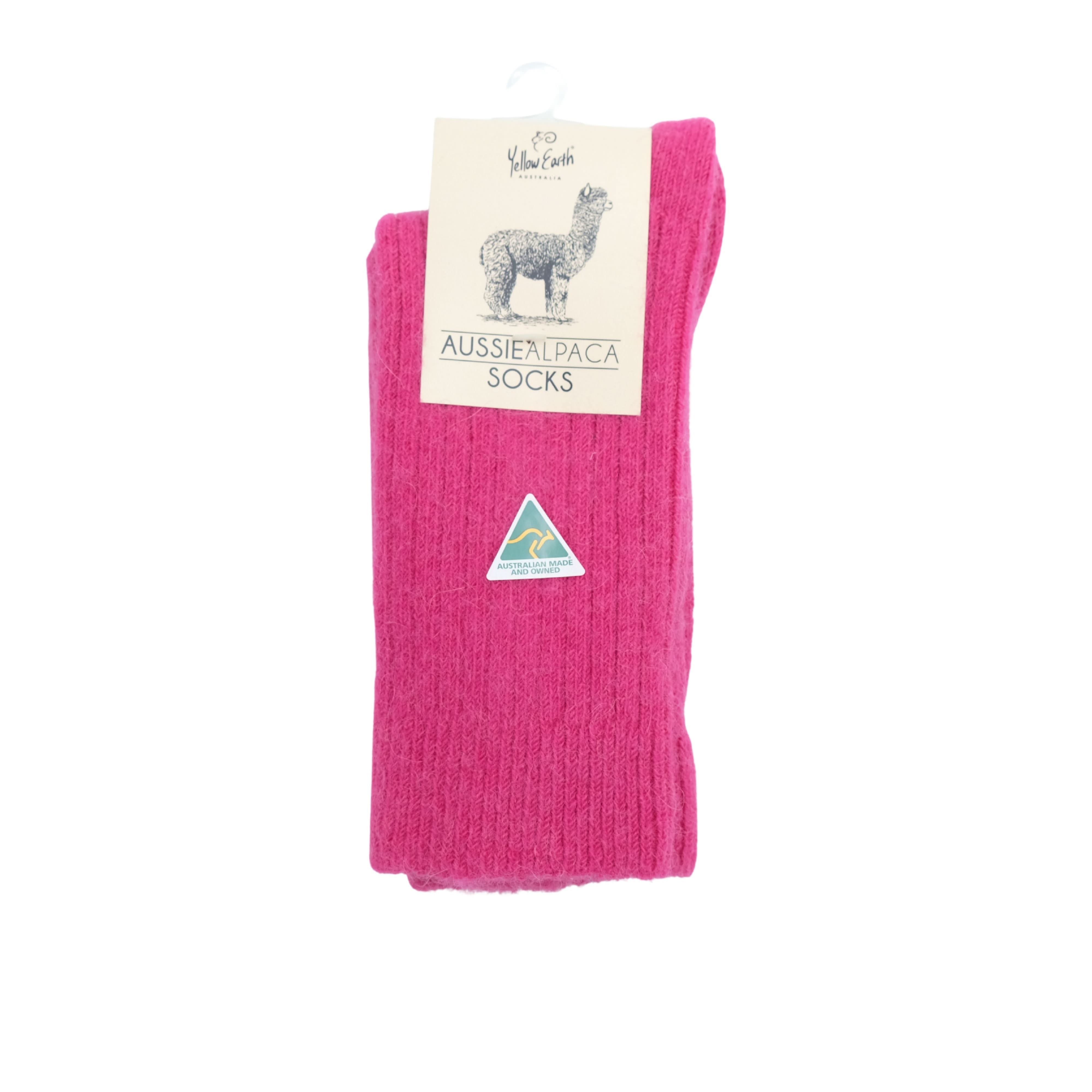 Bright pink alpaca wool socks displayed flat showing ribbed knit texture and triangular brand label. - Yellow Earth Australia