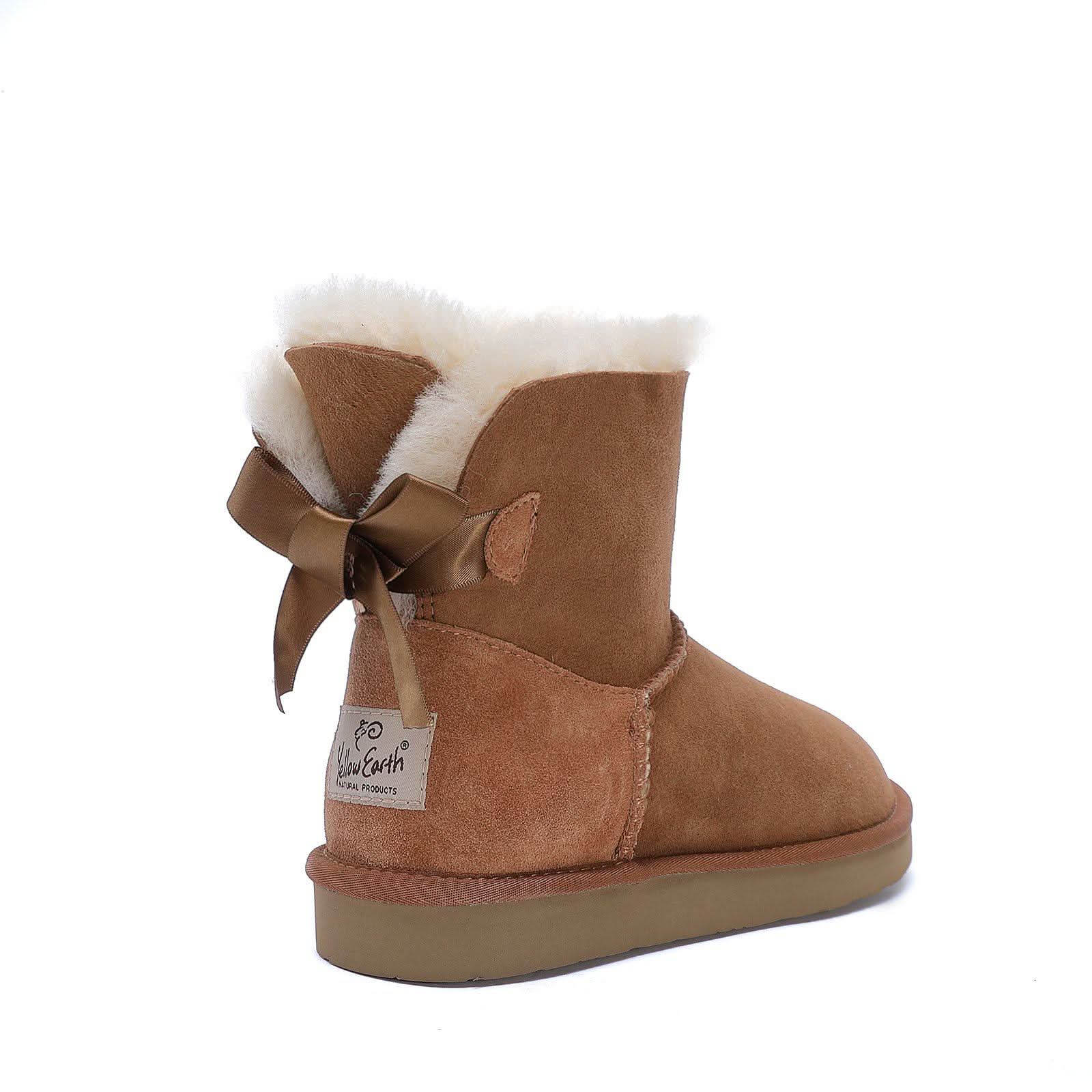 Chestnut sheepskin boot with white wool cuff and ribbon bow, rear view. - Yellow Earth Australia