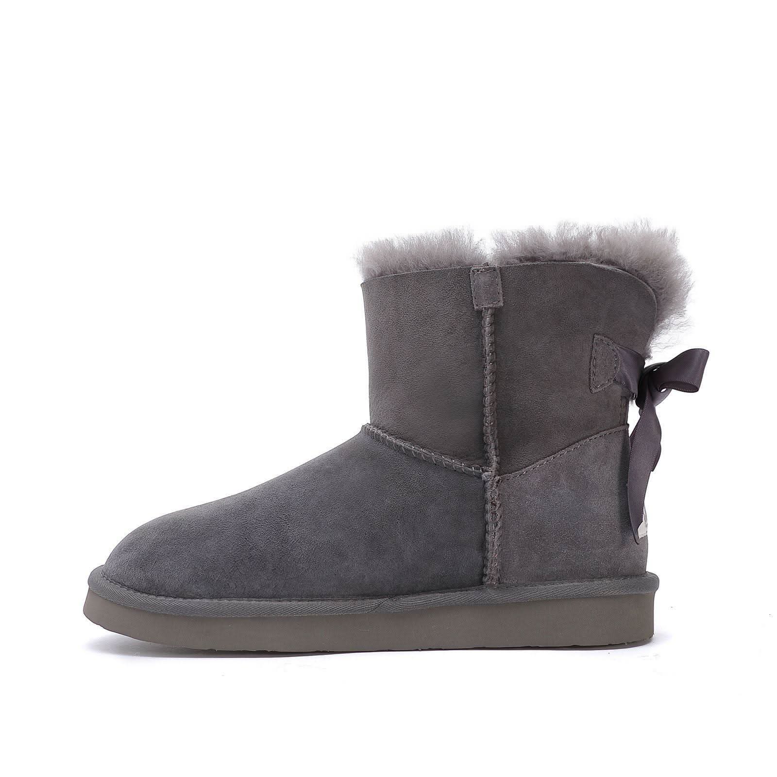 Grey sheepskin boot with fuzzy wool cuff and back bow, side view. - Yellow Earth Australia