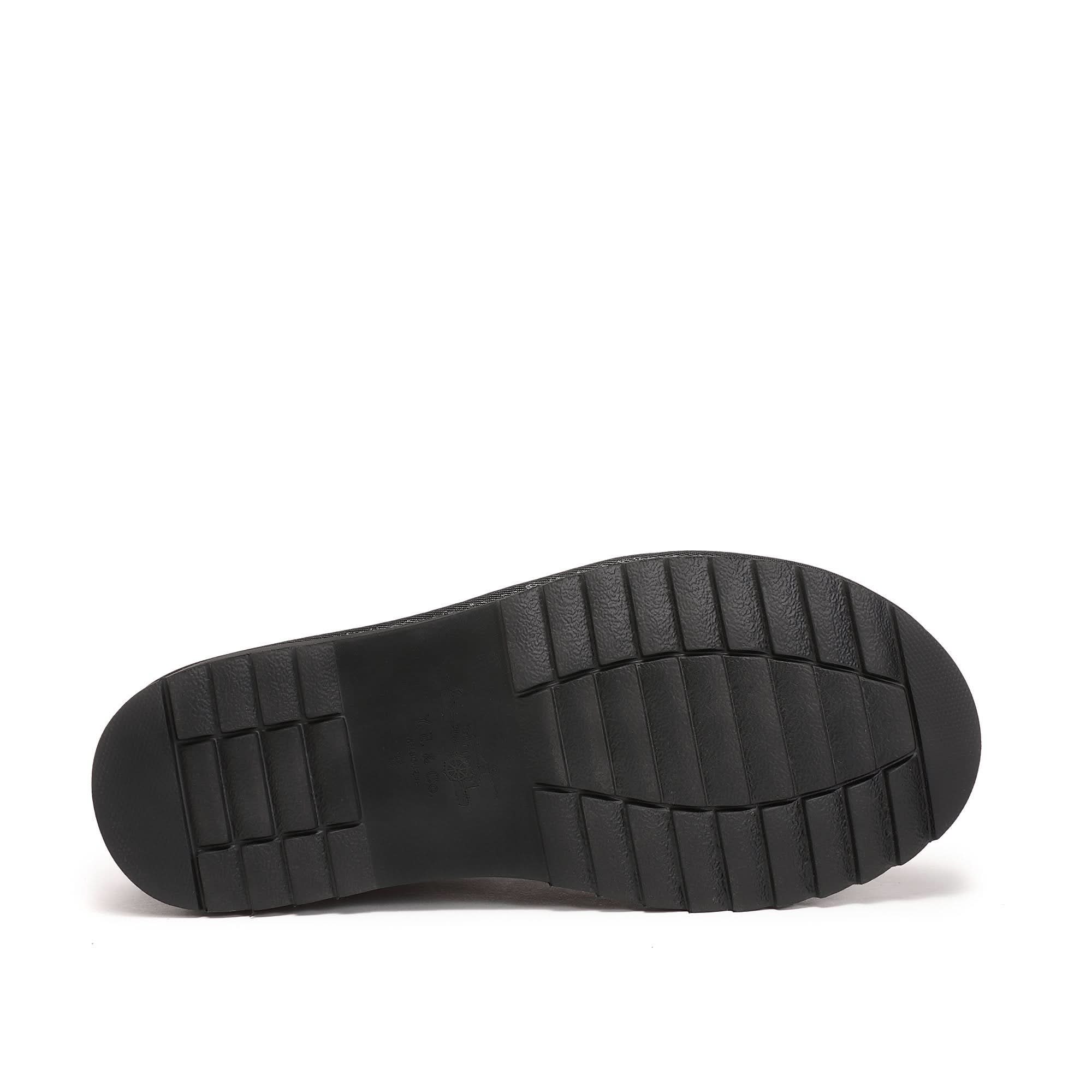 Black sheepskin slip-on shoe sole view showing textured rubber outsole. - Yellow Earth Australia