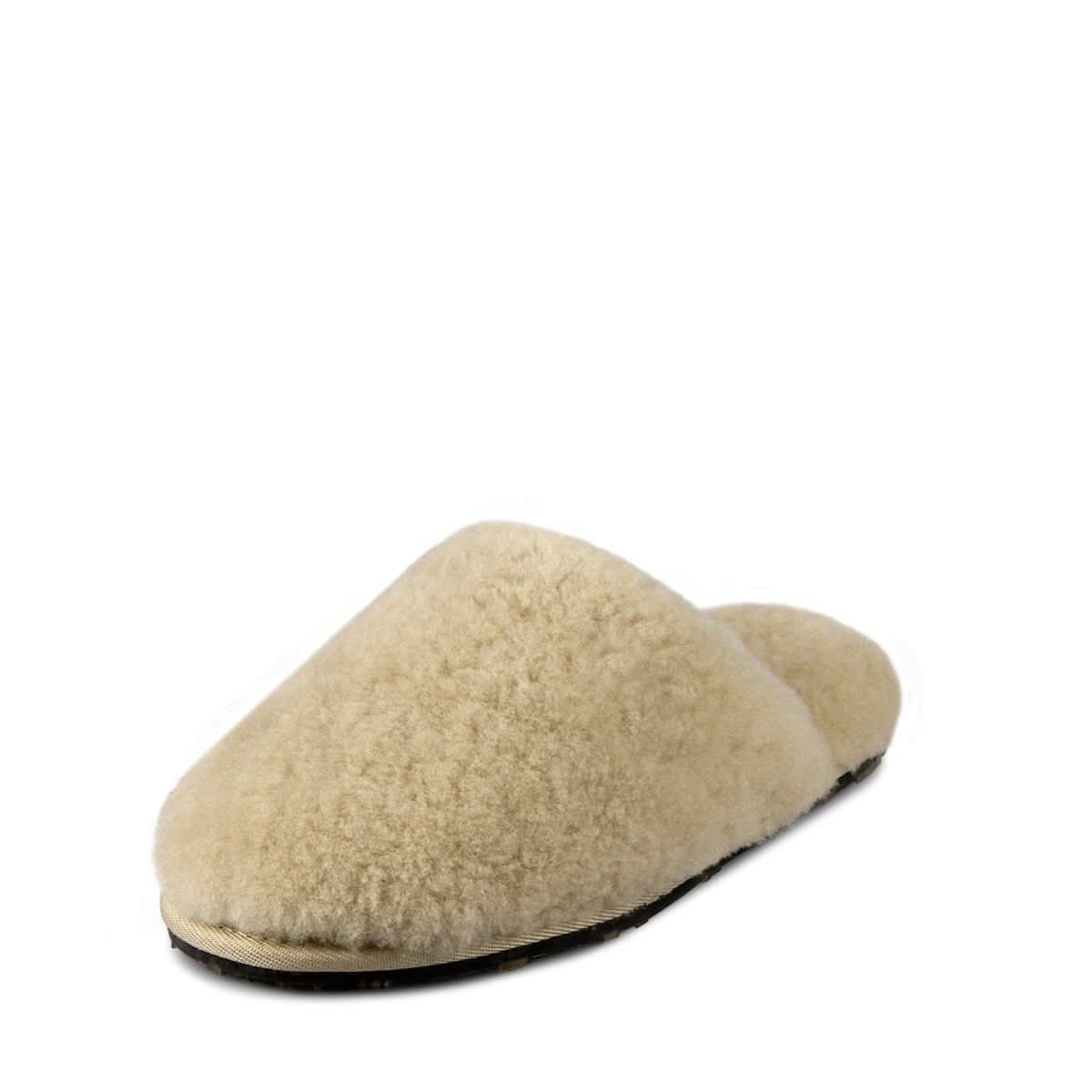 Cream sheepskin slipper with fluffy wool upper and dark sole, side angle view. - Yellow Earth Australia