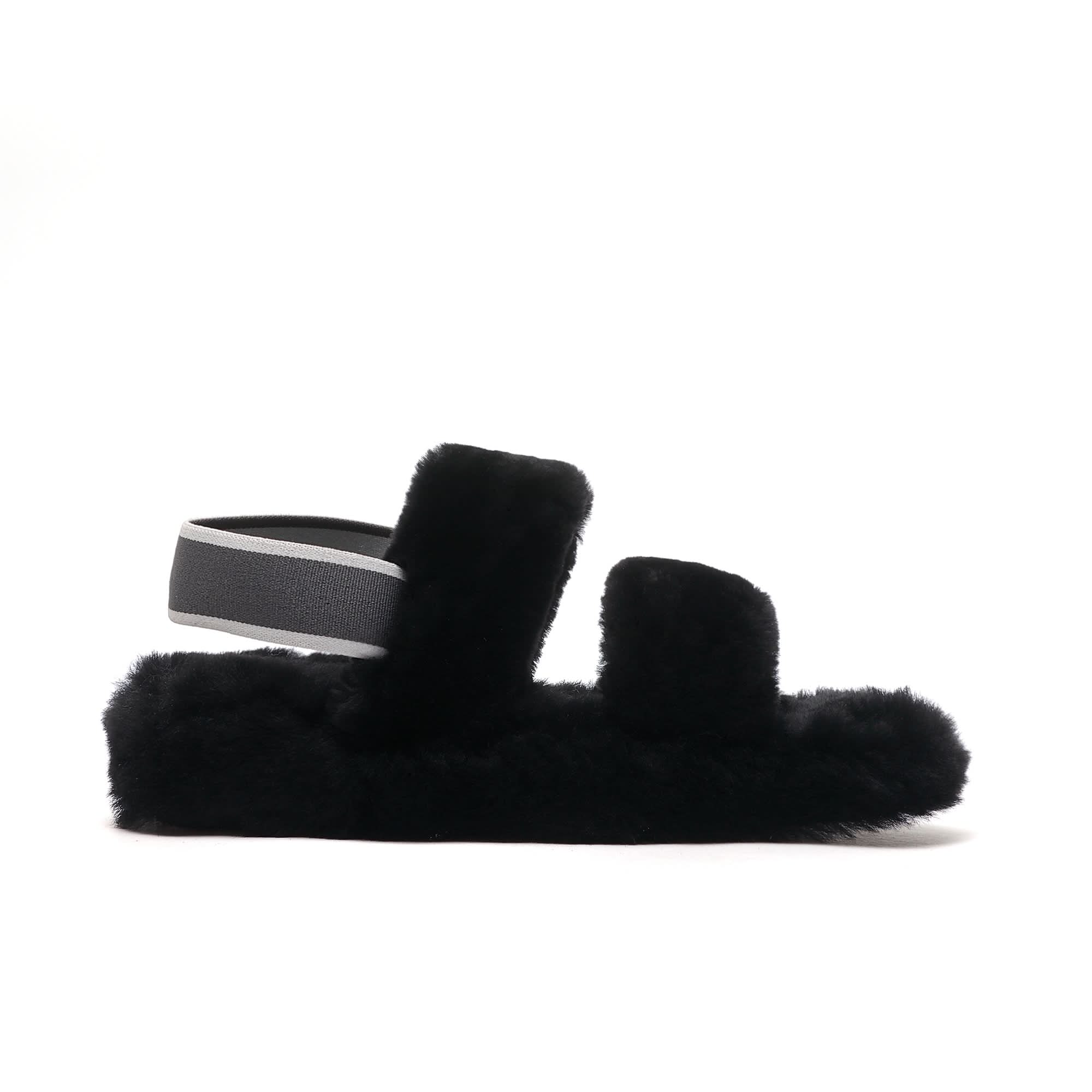 Black fluffy sheepskin slipper with grey fabric trim, side view. - Yellow Earth Australia