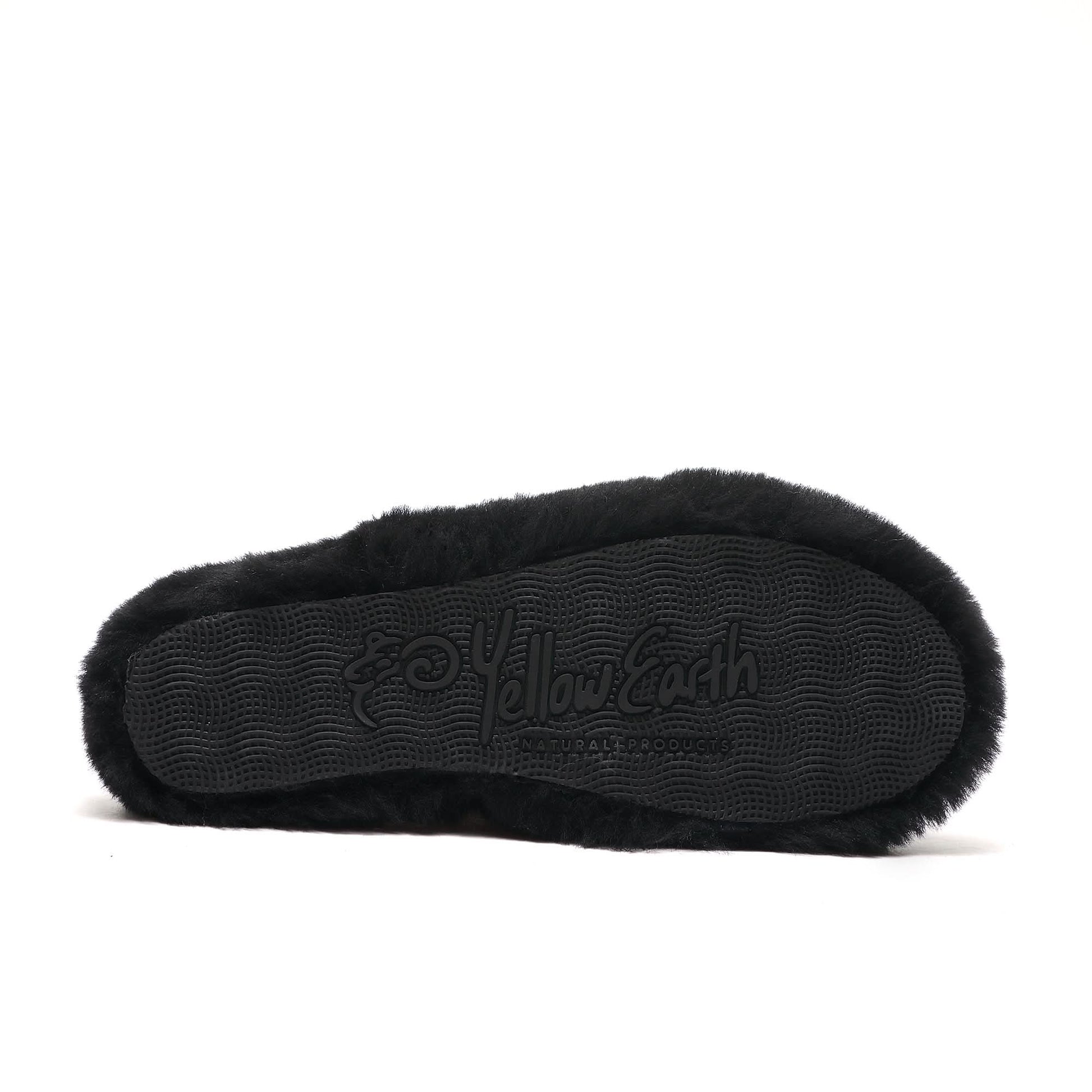Black sheepskin slipper sole with textured grip pattern, viewed from underneath. - Yellow Earth Australia