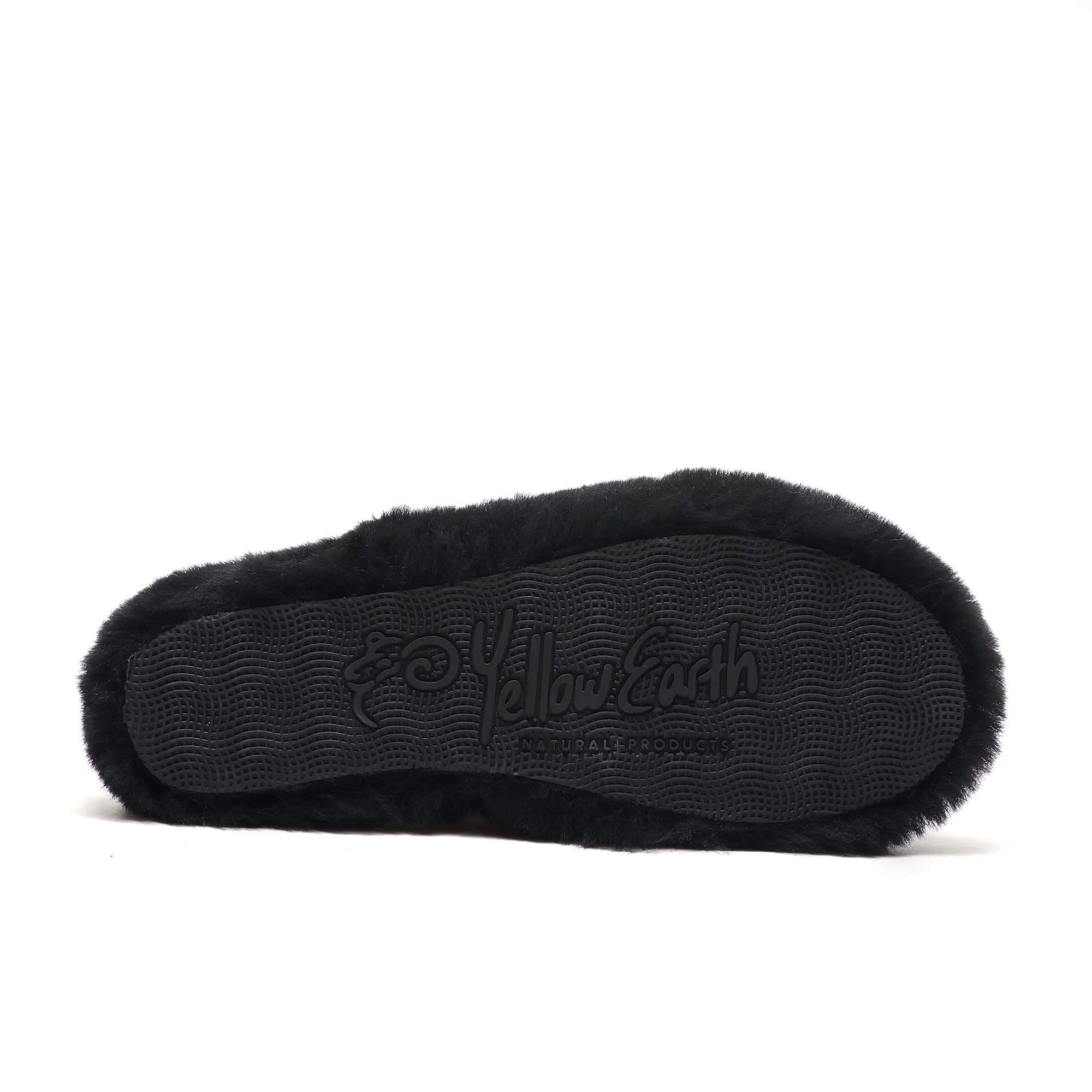 Black sheepskin slipper sole with textured grip pattern, viewed from underneath. - Yellow Earth Australia