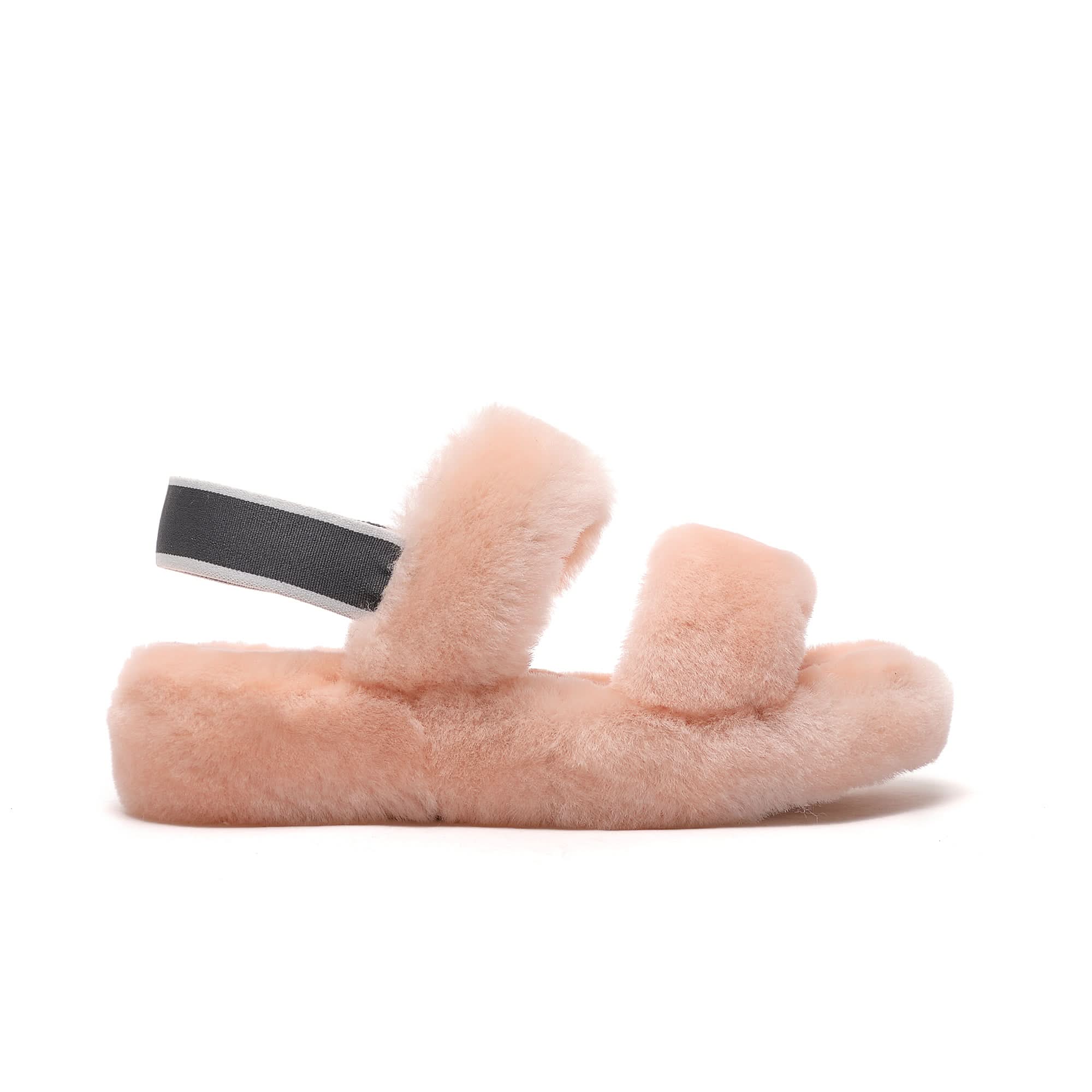 Pink fluffy sheepskin slippers with black strap, viewed from the side. - Yellow Earth Australia