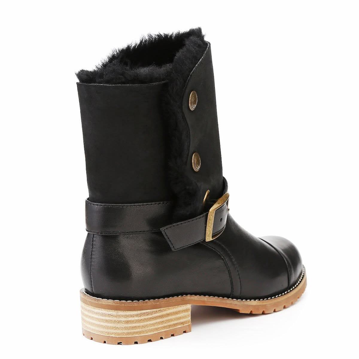 Black sheepskin mid-calf boot with fur lining and tan lug sole, rear three-quarter view. - Yellow Earth Australia