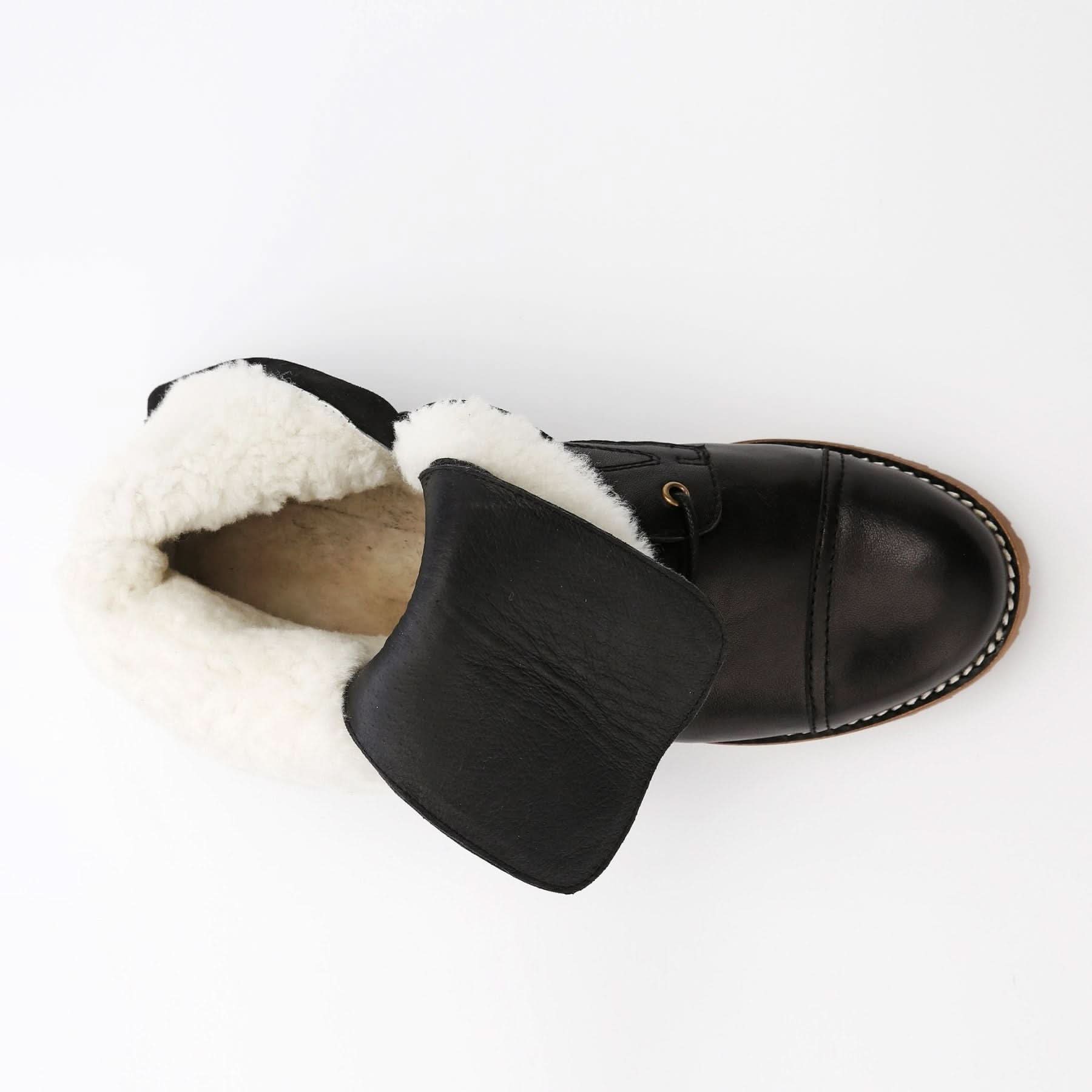 Black leather sheepskin-lined boot with cream wool collar, top-down view. - Yellow Earth Australia