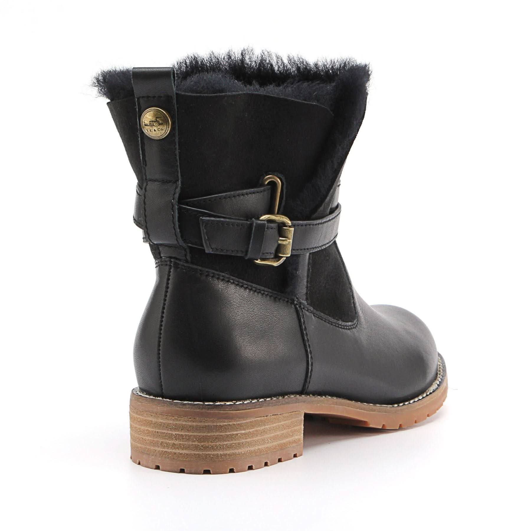 Black sheepskin boot with fur collar and buckle strap, rear view. - Yellow Earth Australia