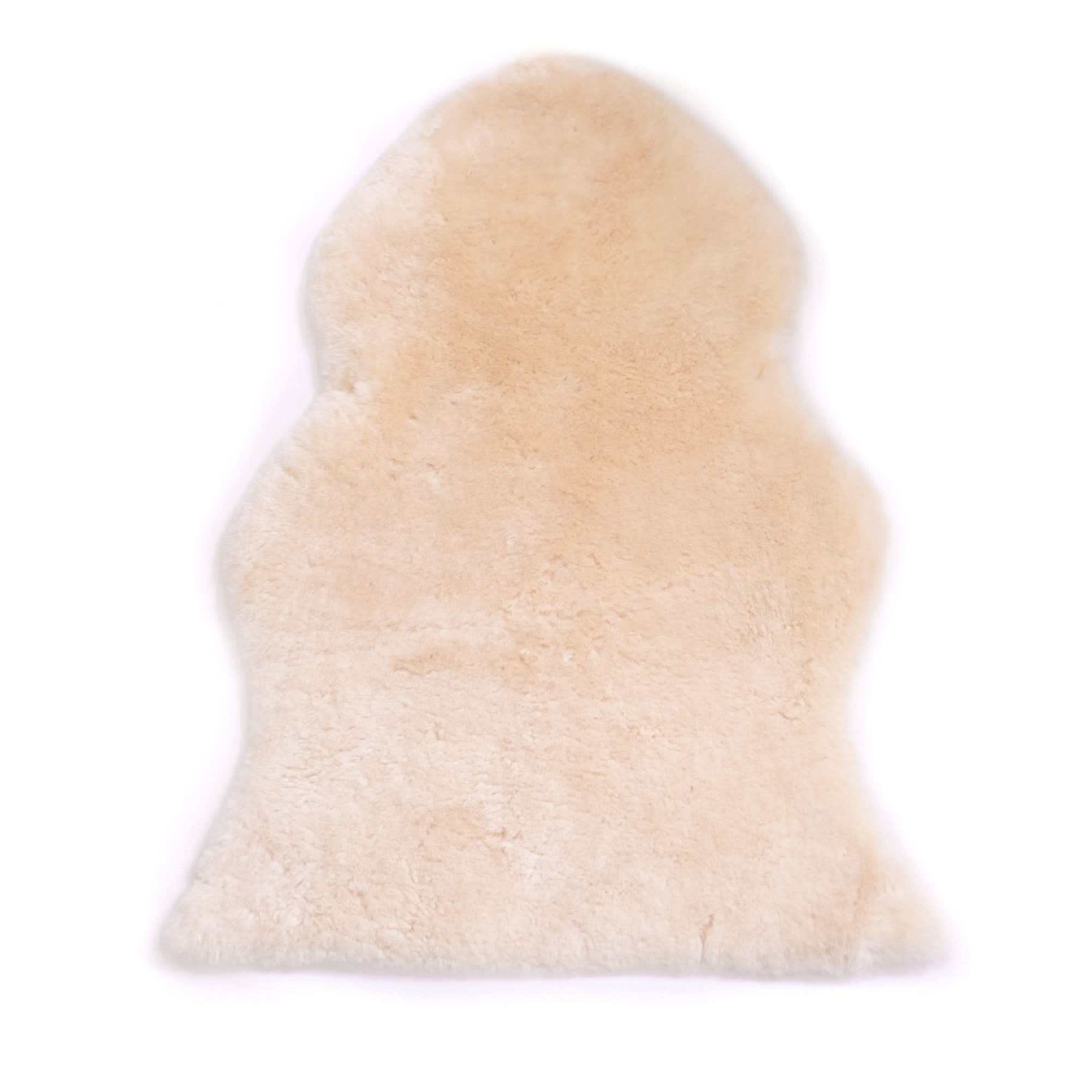 Cream sheepskin rug with soft wool pile viewed from above on white background. - Yellow Earth Australia