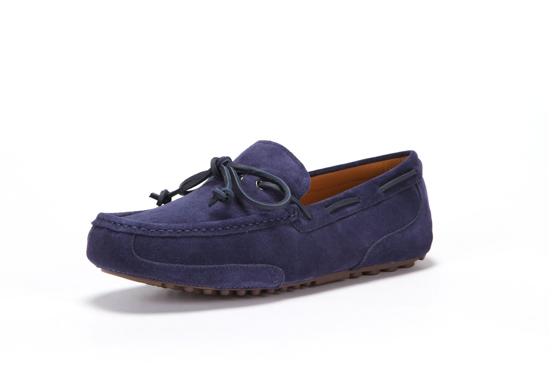 Men's navy suede moccasin with leather laces and rubber sole on white background
