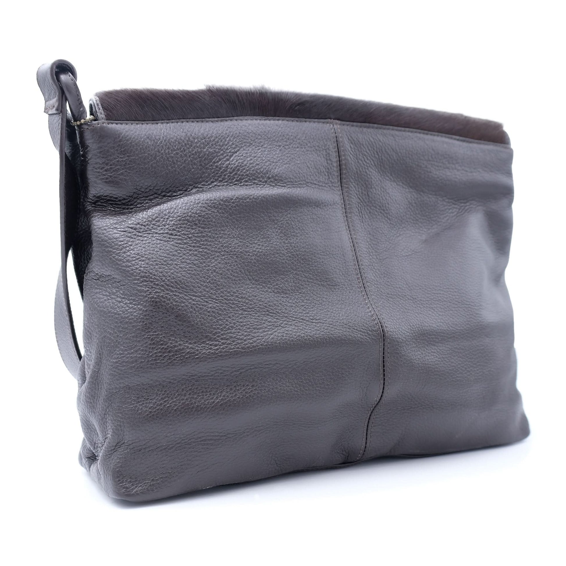 Grey leather shoulder bag with dark sheepskin wool trim, back angled view. - Yellow Earth Australia