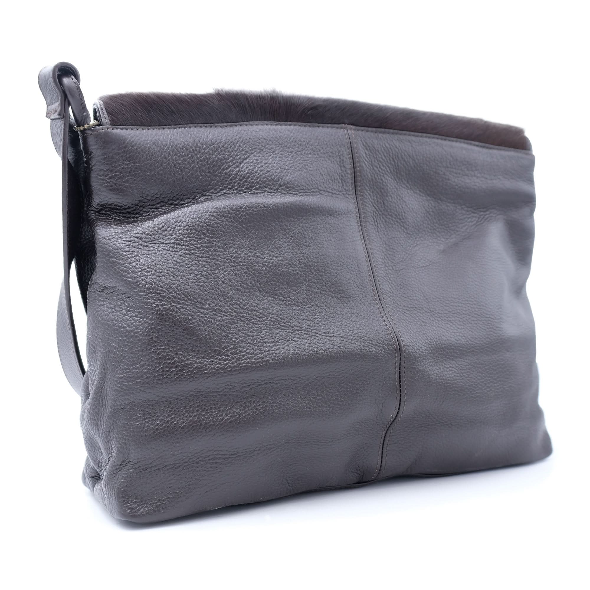 Grey leather shoulder bag with dark sheepskin wool trim, back angled view. - Yellow Earth Australia
