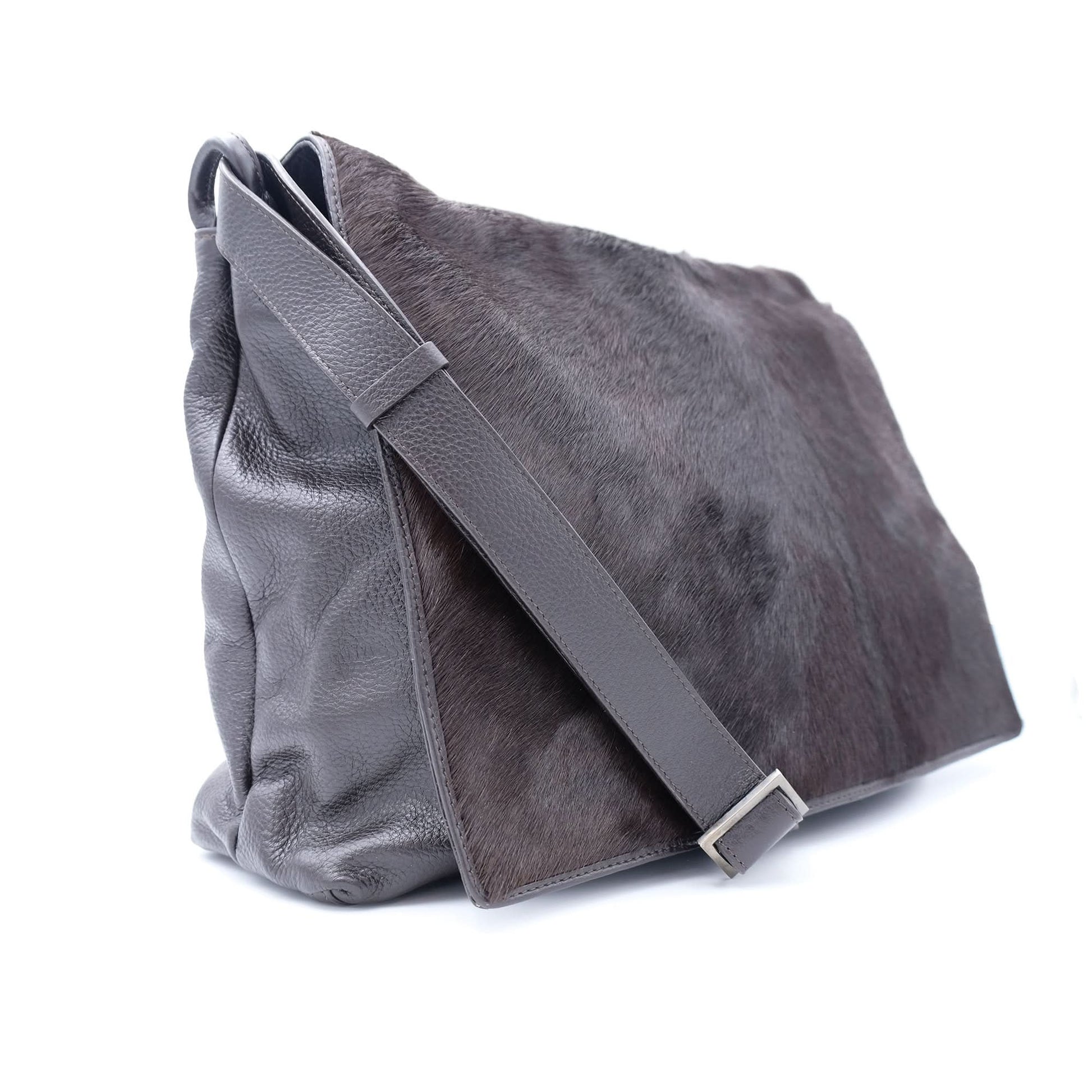 Grey sheepskin leather messenger bag with hairy wool texture, side view. - Yellow Earth Australia