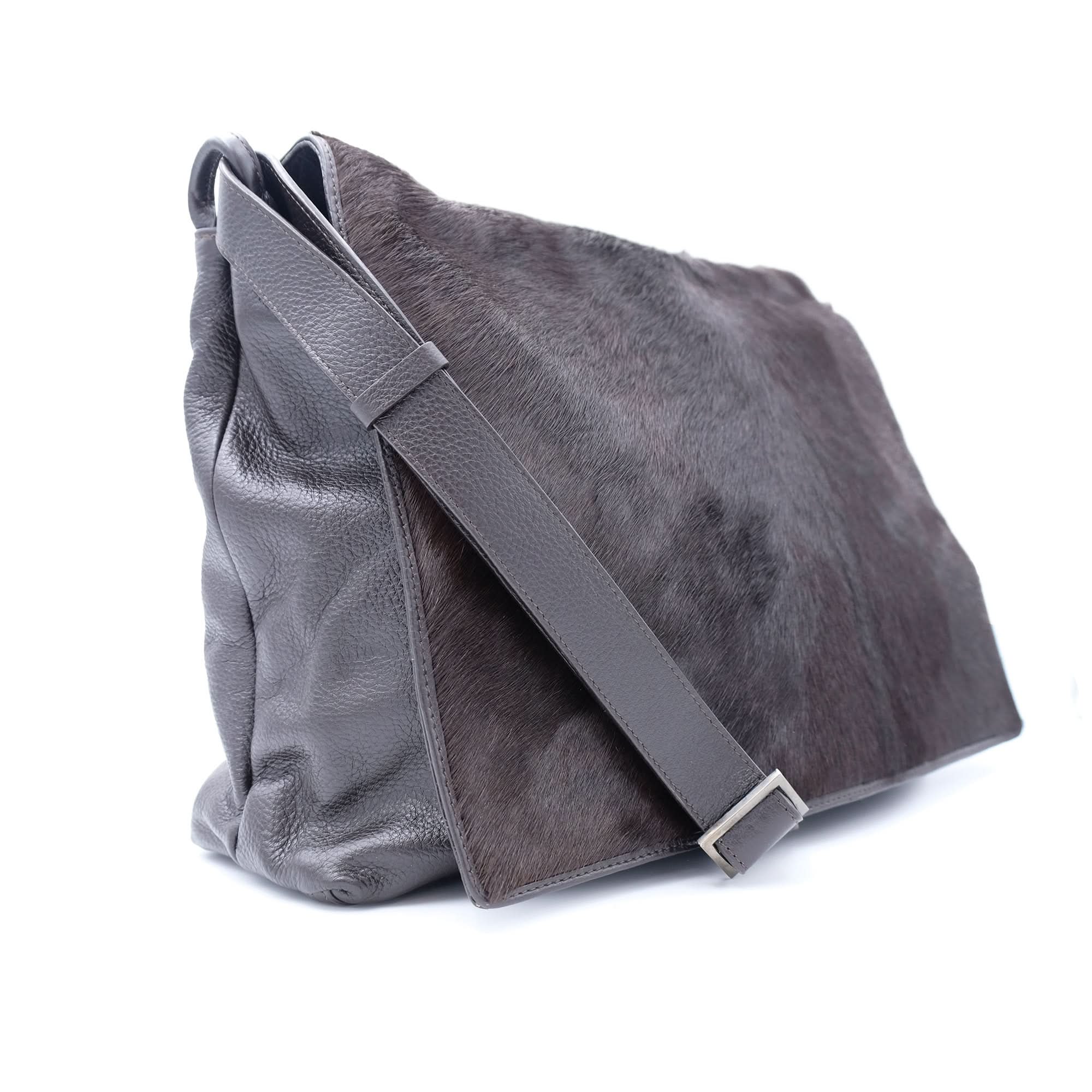 Grey sheepskin leather messenger bag with hairy wool texture, side view. - Yellow Earth Australia