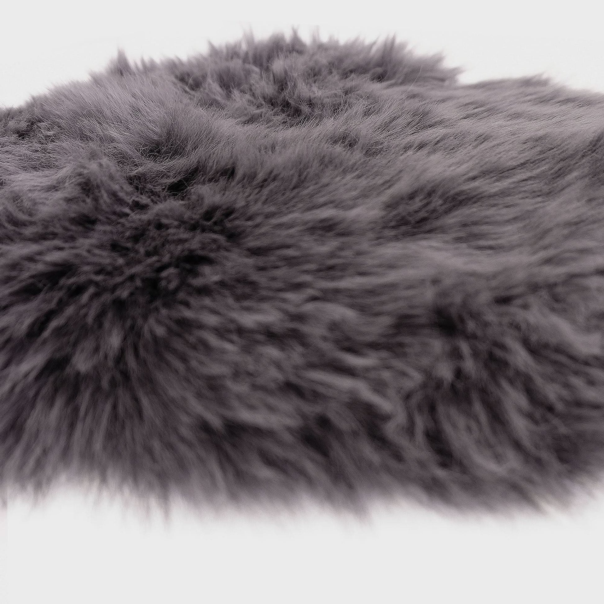 Grey sheepskin rug with soft wool texture, angled overhead view on white background. - Yellow Earth Australia
