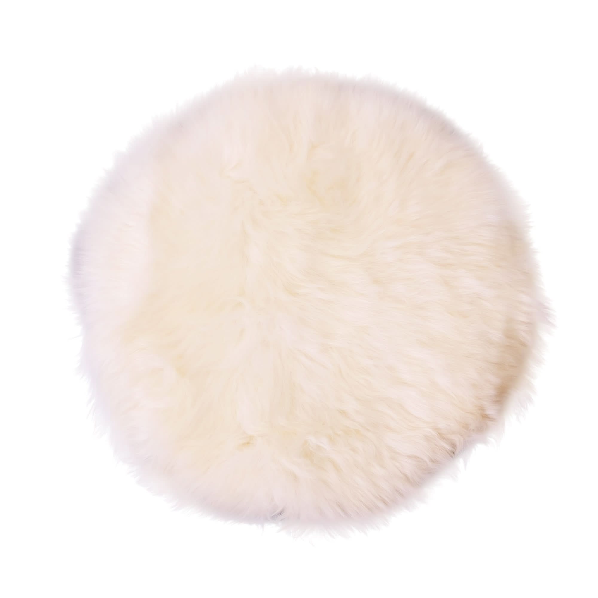 Ivory sheepskin circular cushion with plush wool texture, top view. - Yellow Earth Australia
