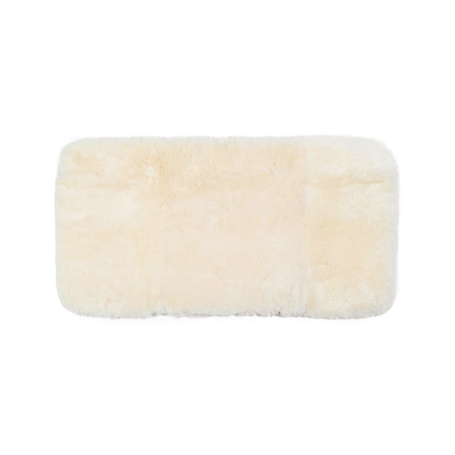 Rectangular cream sheepskin rug with soft wool pile, viewed from above on white background. - Yellow Earth Australia