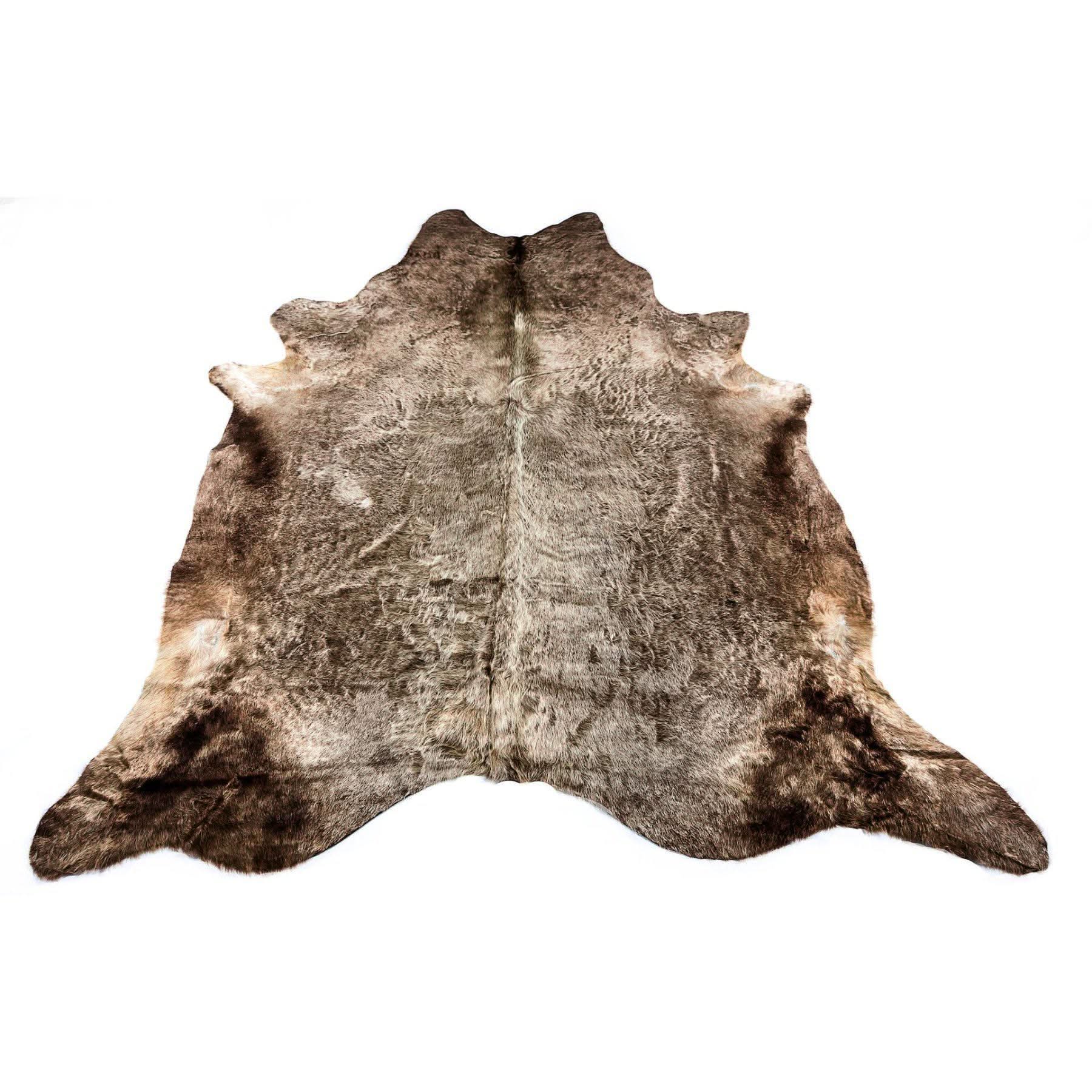 Natural brown and white cowhide rug displayed flat against white background. - Yellow Earth Australia