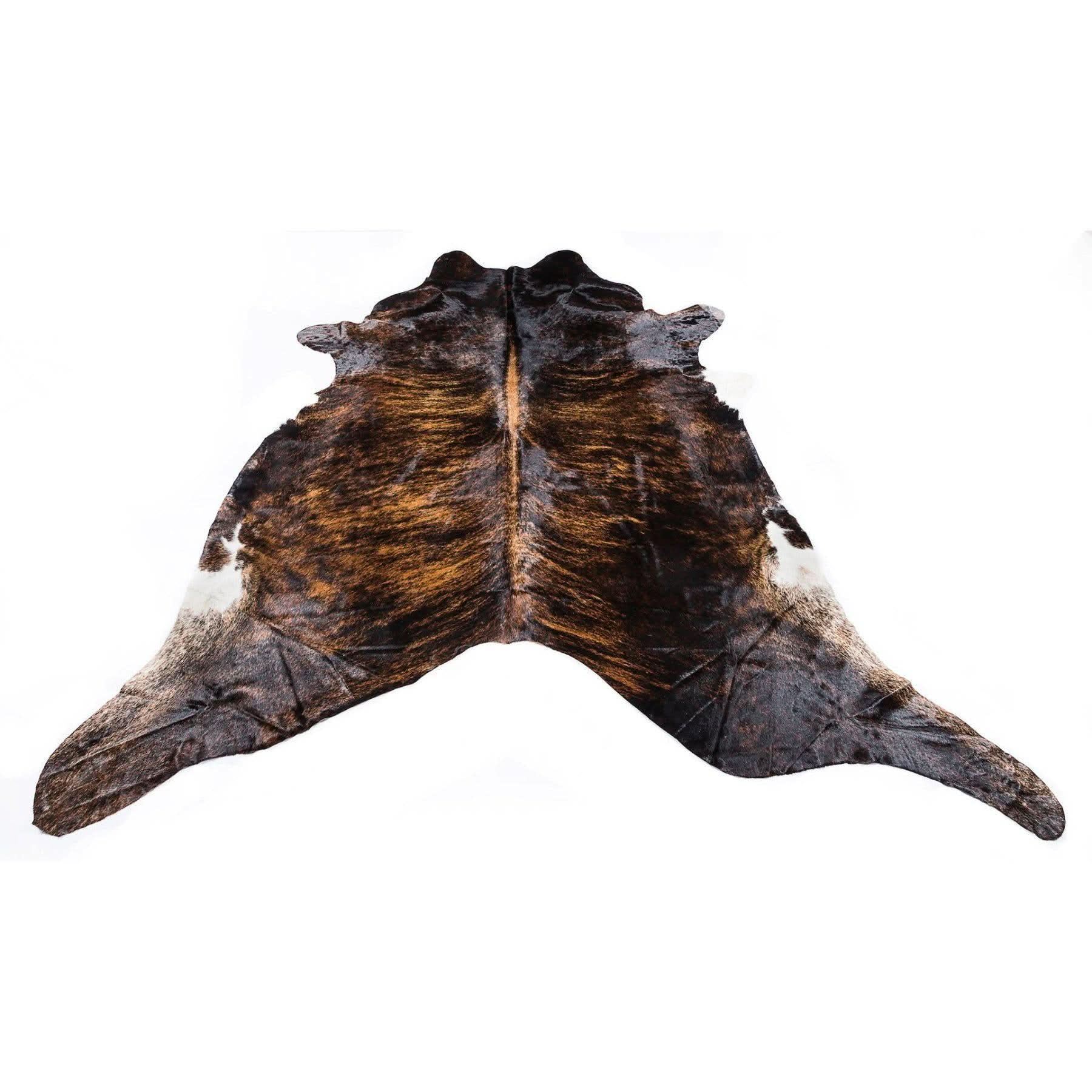 Genuine sheepskin rug with brown and white cow hide pattern, top-down view. - Yellow Earth Australia