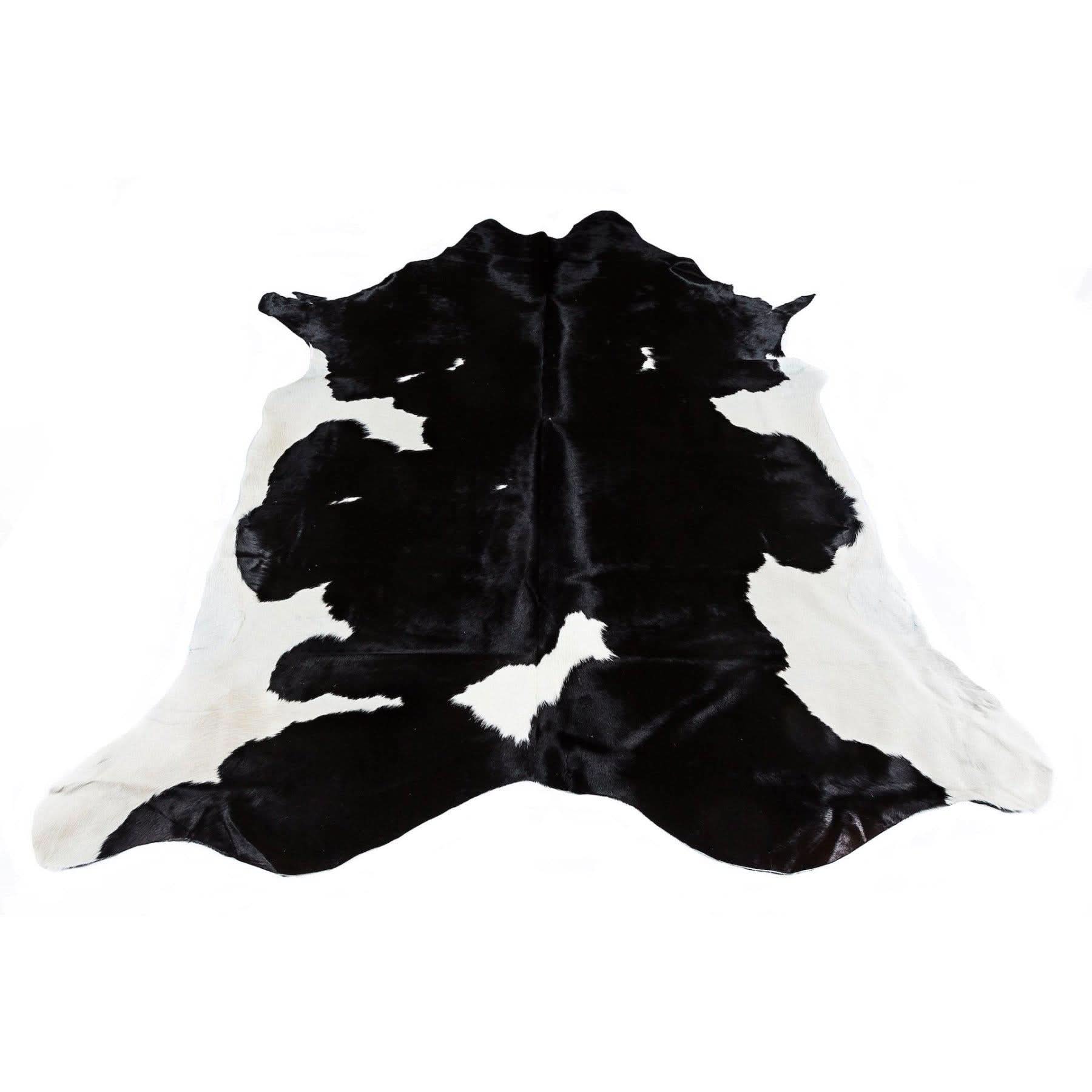 Black and white cowhide rug displayed flat showing natural fur texture and markings. - Yellow Earth Australia