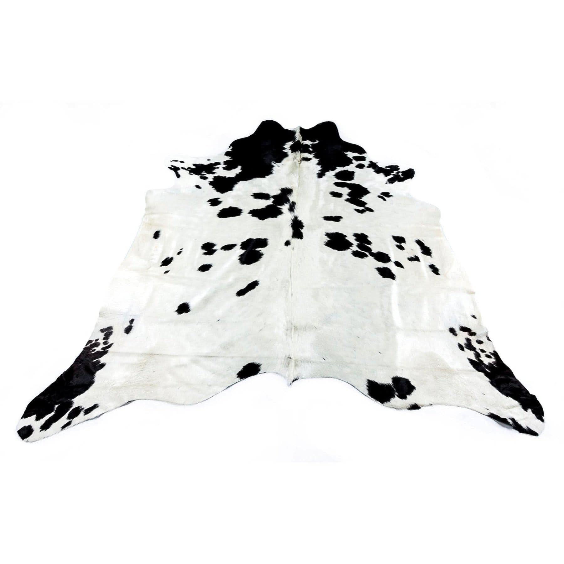 Black and white cowhide rug with natural fur texture, flat lay view. - Yellow Earth Australia