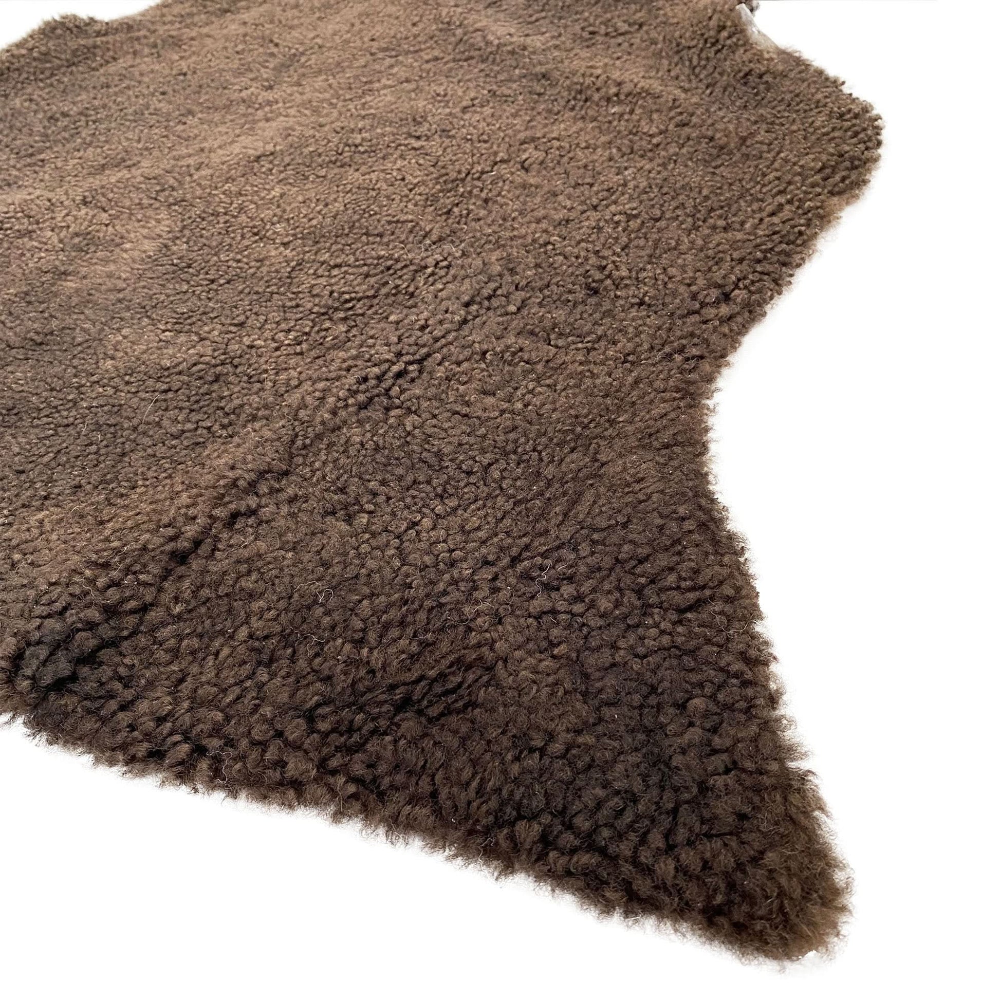Taupe sheepskin rug with thick wool pile viewed from above at an angle. - Yellow Earth Australia