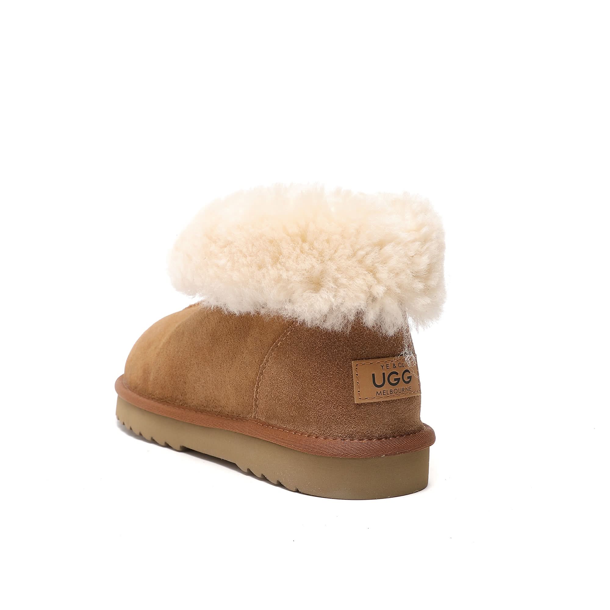 Chestnut sheepskin UGG boot with plush cream fleece cuff and tan sole on white background