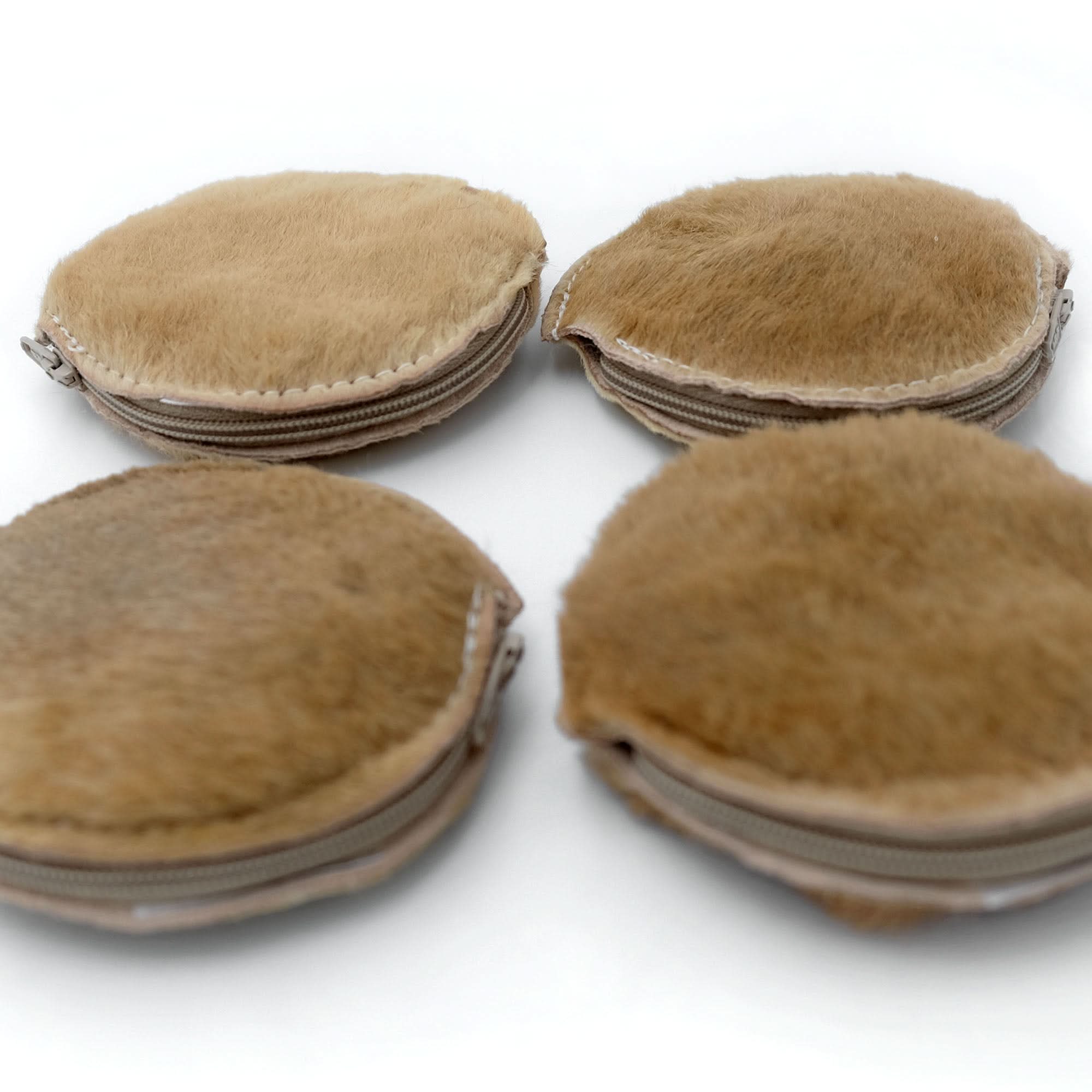Four tan sheepskin coin purses with zippered closures, top and front view. - Yellow Earth Australia