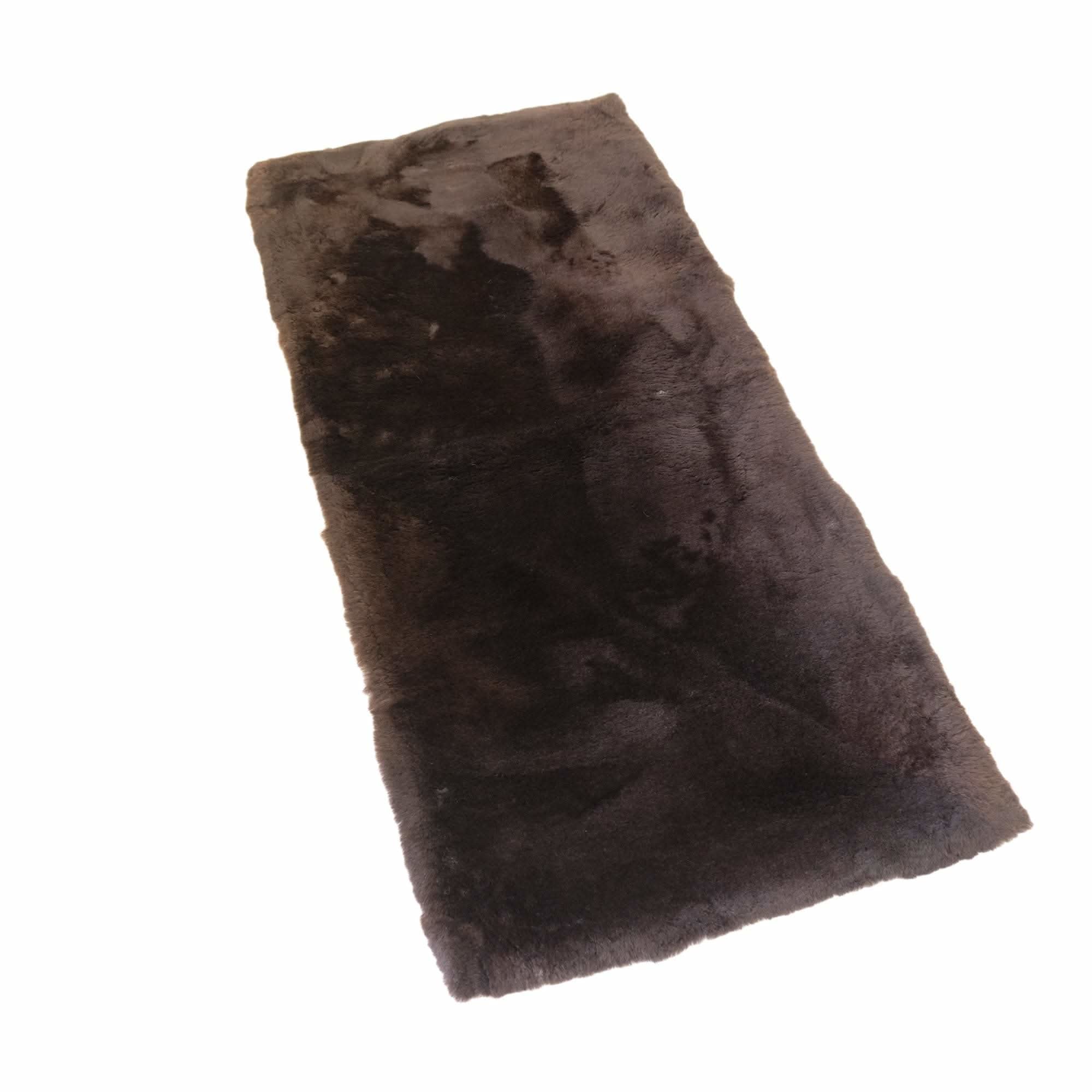 Chocolate brown sheepskin rug with soft wool pile, angled top view on white background. - Yellow Earth Australia
