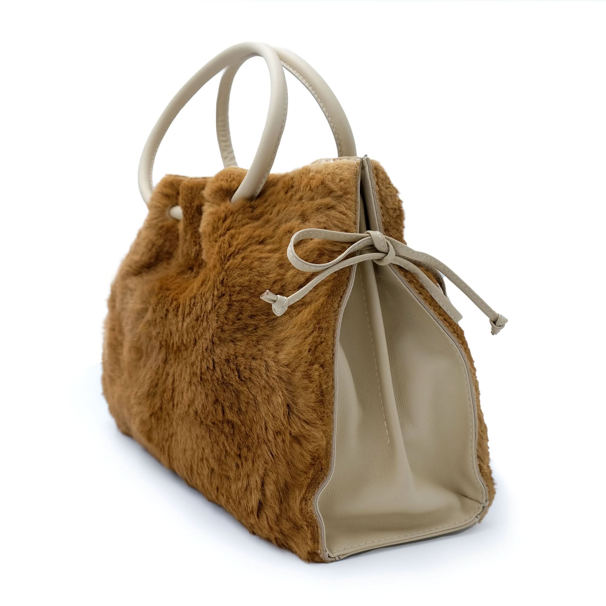 Caramel fuzzy sheepskin tote bag with cream leather handles, side view. - Yellow Earth Australia