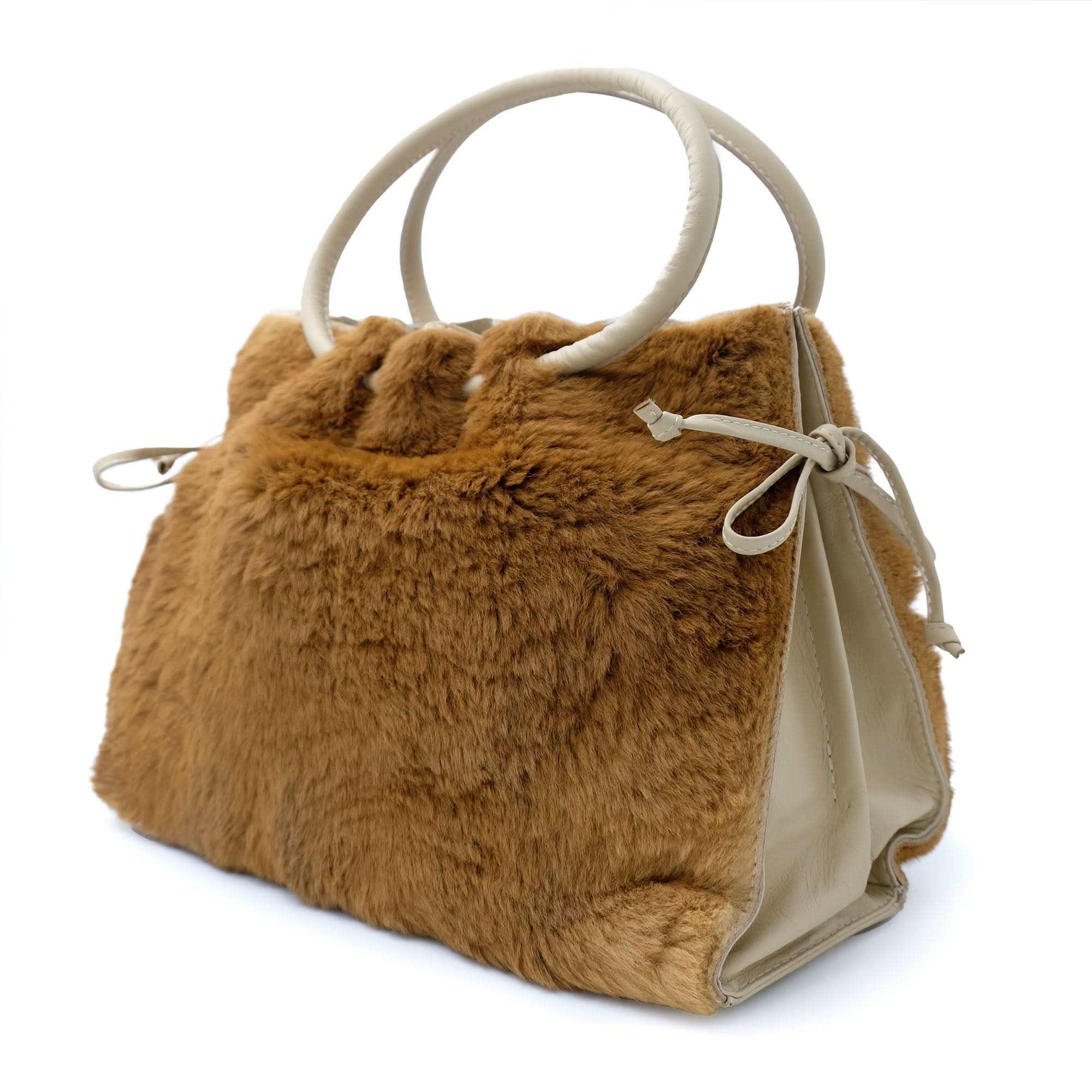 Tan sheepskin handbag with cream handles, side view showcasing soft fluffy fur texture. - Yellow Earth Australia