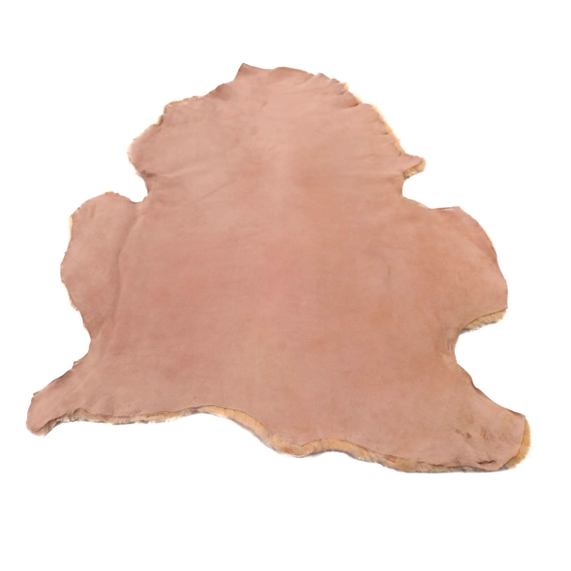Natural sheepskin rug in soft pink tone, top view showing fluffy wool texture. - Yellow Earth Australia