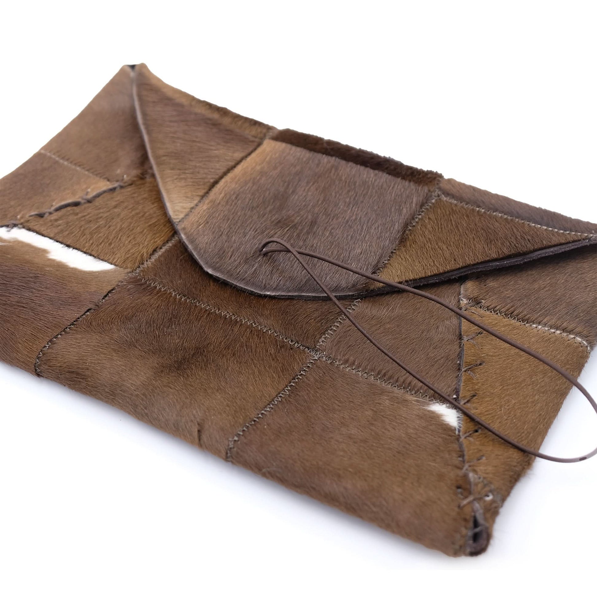 Handcrafted patchwork sheepskin clutch in warm brown tones, tied with leather cord. - Yellow Earth Australia