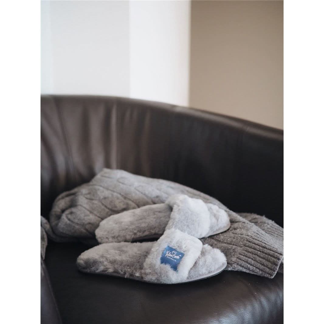 Cream and grey wool slippers with sheepskin lining on dark leather chair. - Yellow Earth Australia