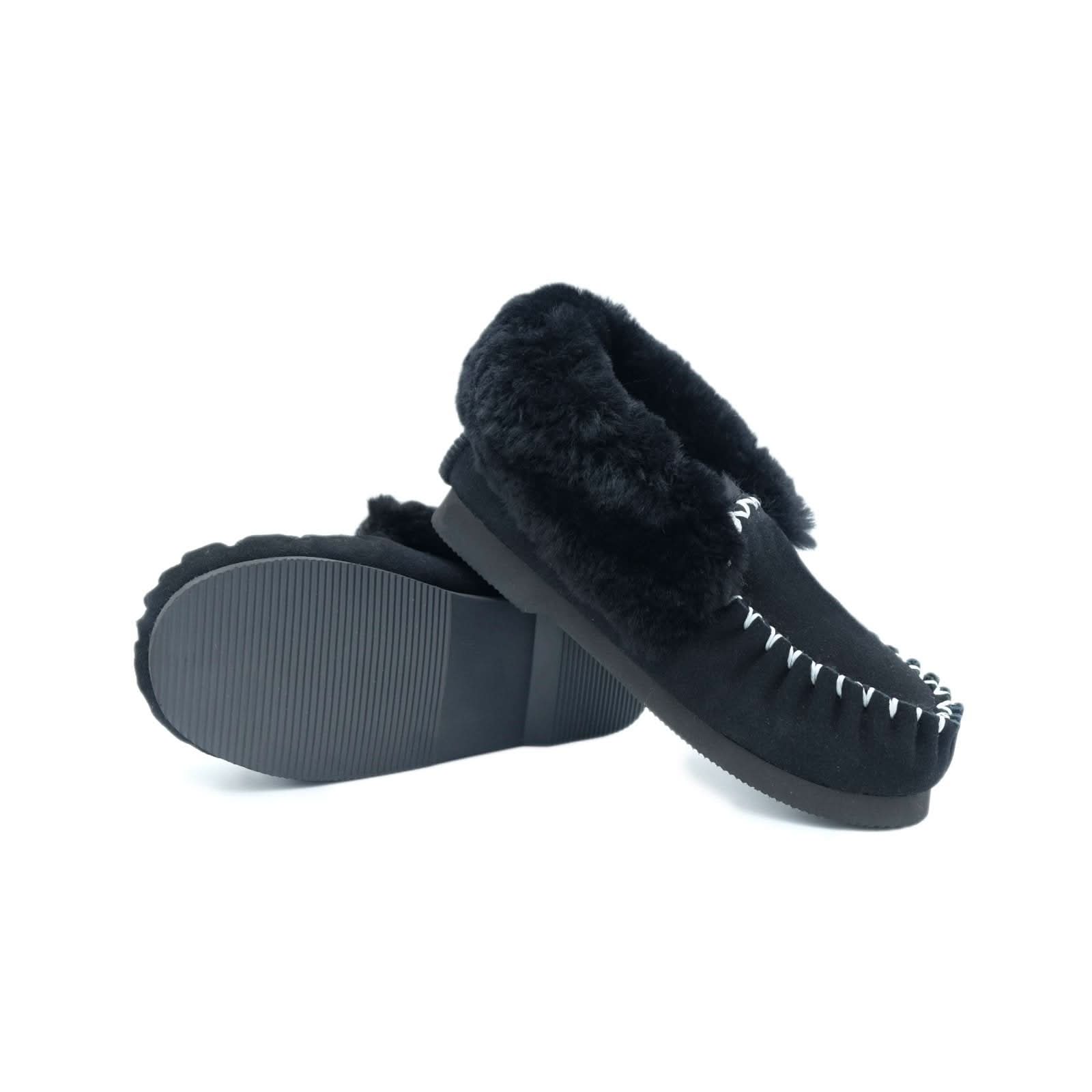 Black sheepskin moccasin slippers with fur cuff, shown from above displaying sole. - Yellow Earth Australia