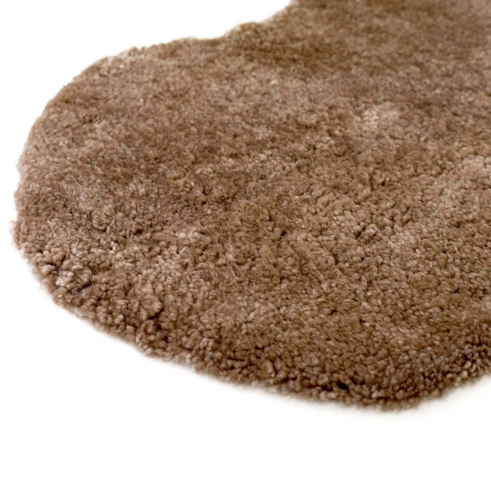 Pile of natural beige sheepskin wool powder viewed from above on white background. - Yellow Earth Australia