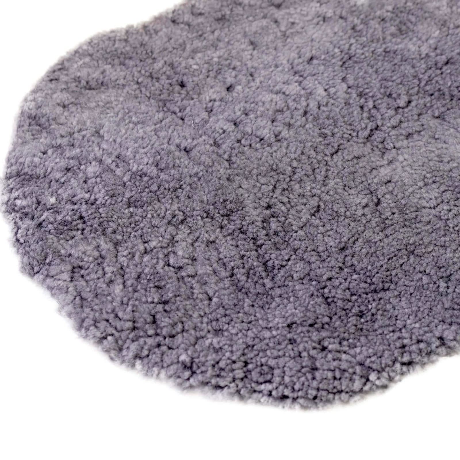 Grey sheepskin rug with fluffy wool pile texture, overhead view. - Yellow Earth Australia