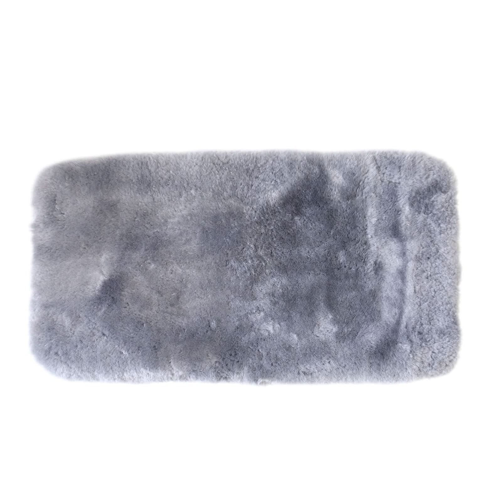 Soft grey sheepskin rug with plush wool pile texture, top-down view on white background. - Yellow Earth Australia