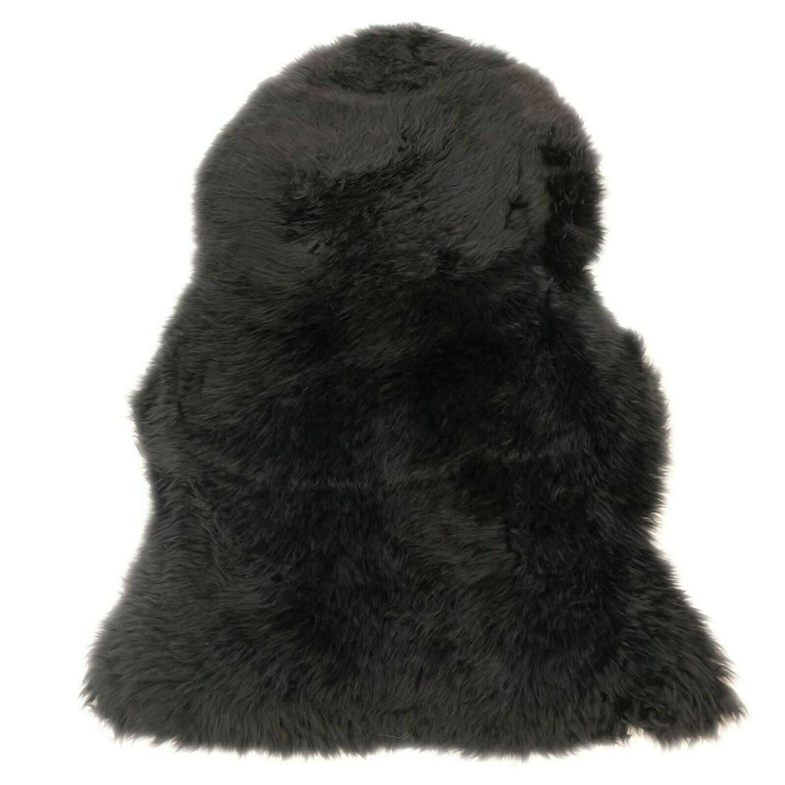 Black sheepskin rug with long wool pile viewed from above on white background. - Yellow Earth Australia