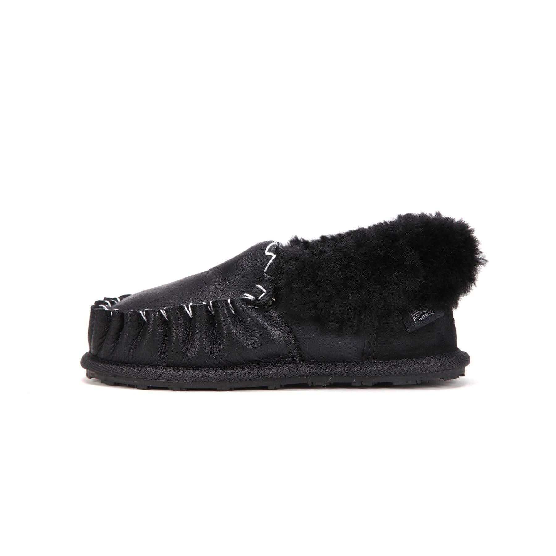 Black leather and sheepskin moccasin slipper with fur collar, shown in side profile view. - Yellow Earth Australia